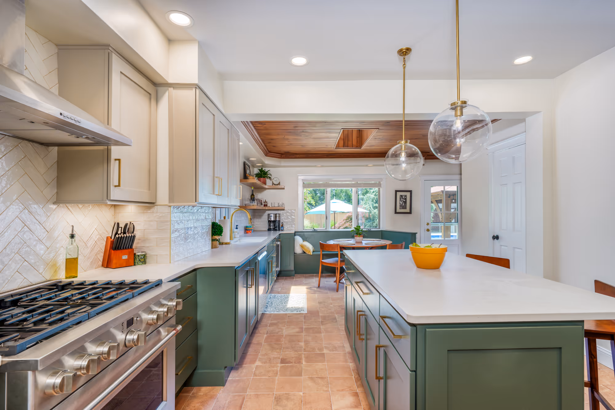 Modern kitchen in Harrisburg, PA featuring green cabinets, wood ceiling, and contemporary lighting.