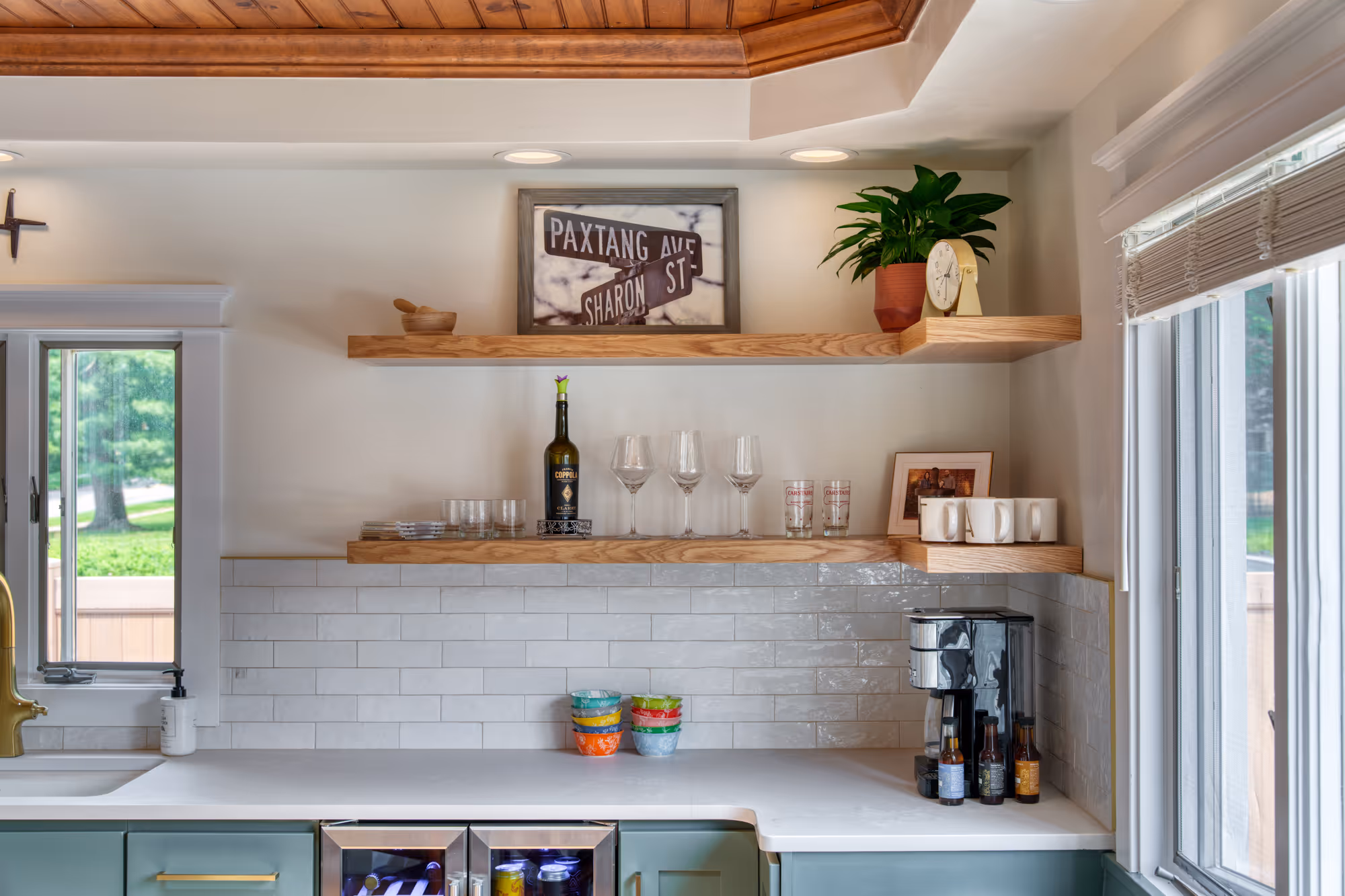 Stylish kitchen featuring open wooden shelving, gray subway tile, and modern appliances in harrisburg, pa
