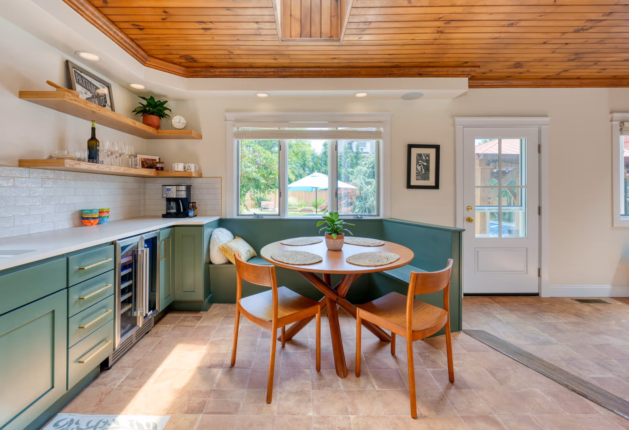 Cozy modern kitchen dining area with green cabinetry and wood accents in harrisburg, pa.