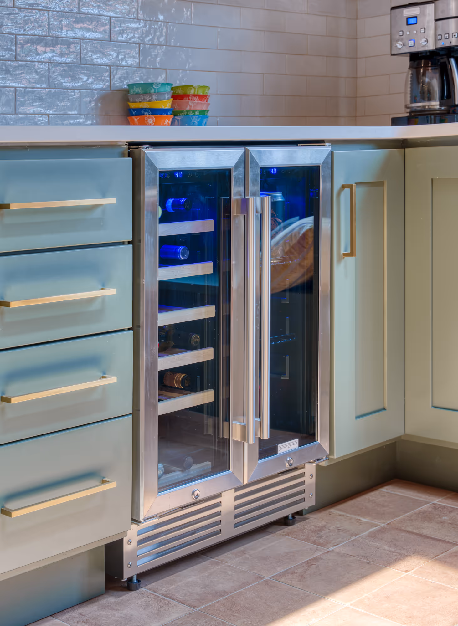 Modern kitchen with a sleek drink cooler and soft green cabinetry in Harrisburg, PA.