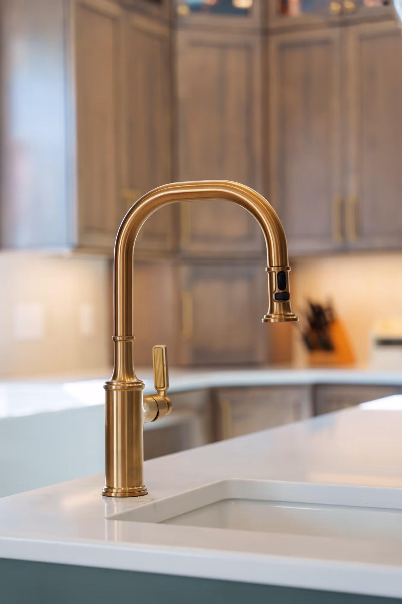 Luxurious kitchen with a brass faucet and sleek white countertop in Harrisburg, PA.