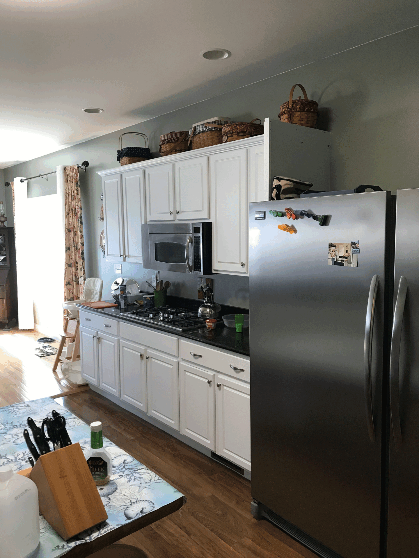 Modern kitchen with white cabinets, stainless steel appliances, and wooden flooring in Harrisburg, PA