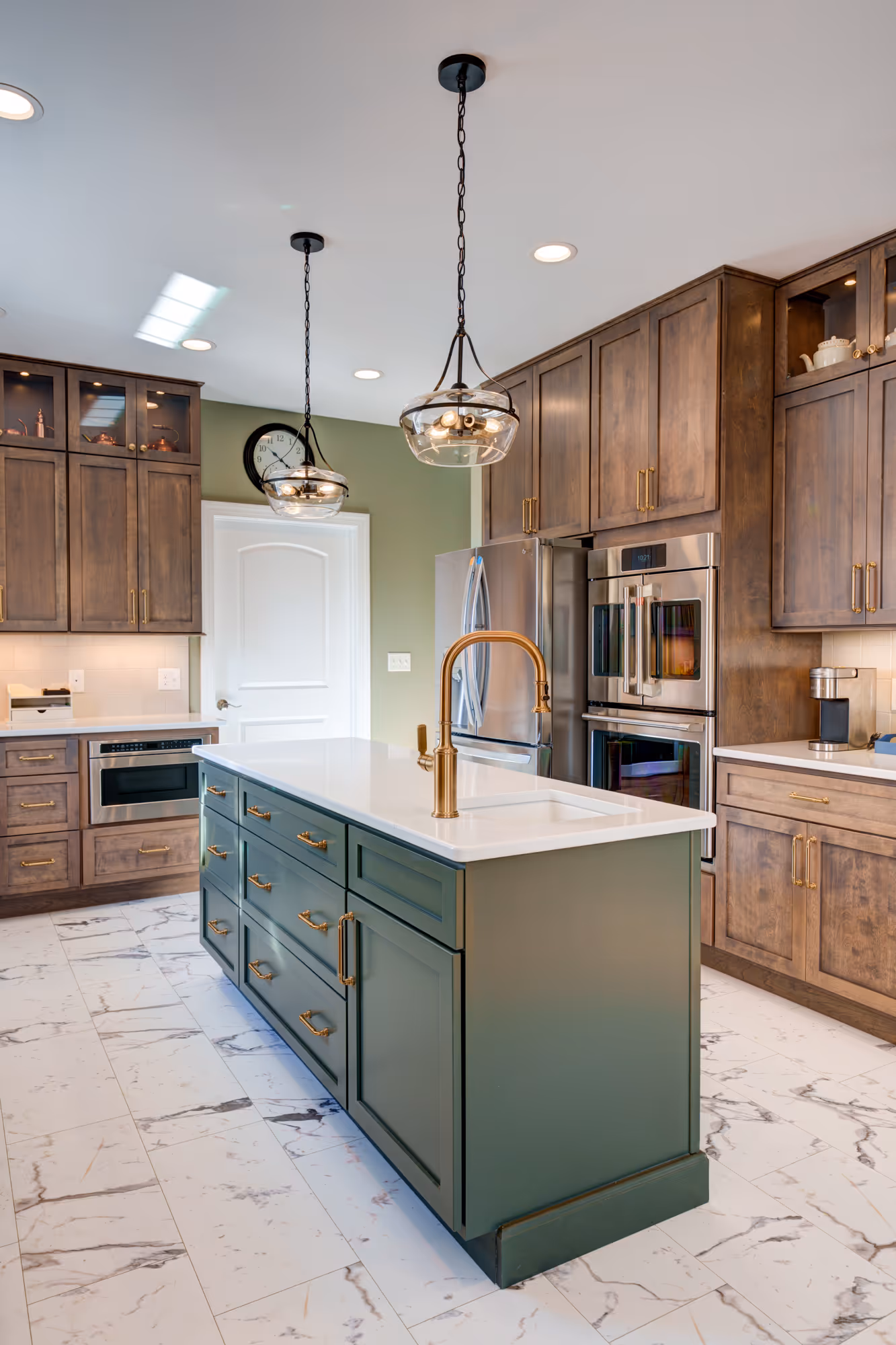 Elegant kitchen with green island, wood cabinets, and modern fixtures in Harrisburg, PA.