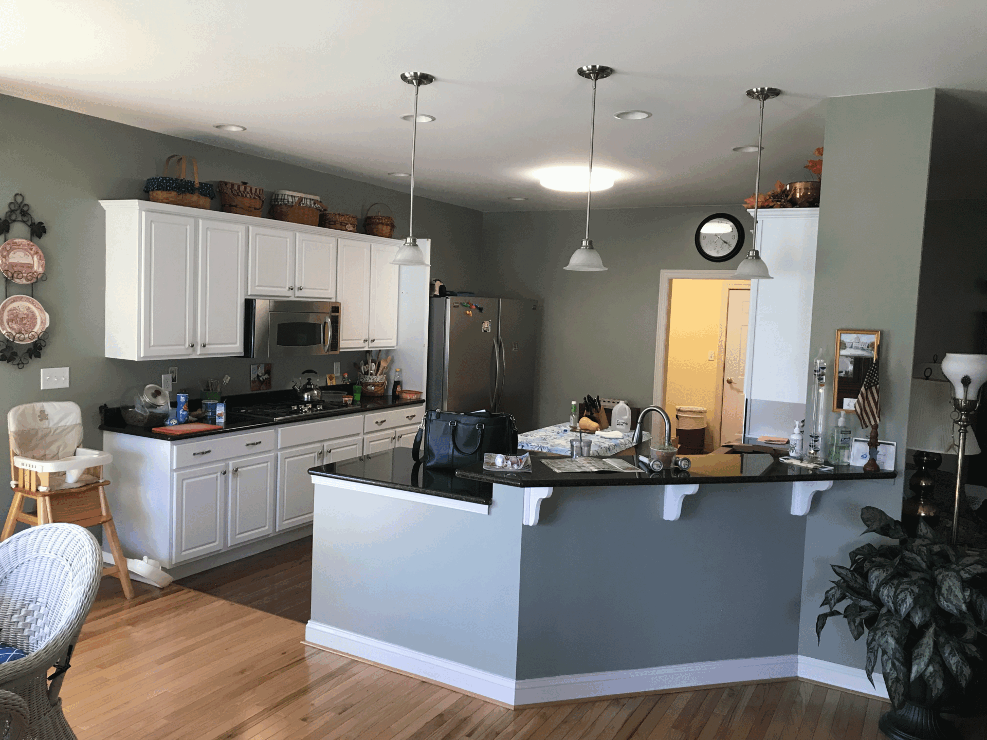 Contemporary kitchen in Harrisburg, PA with white cabinets, black countertop, and modern appliances.