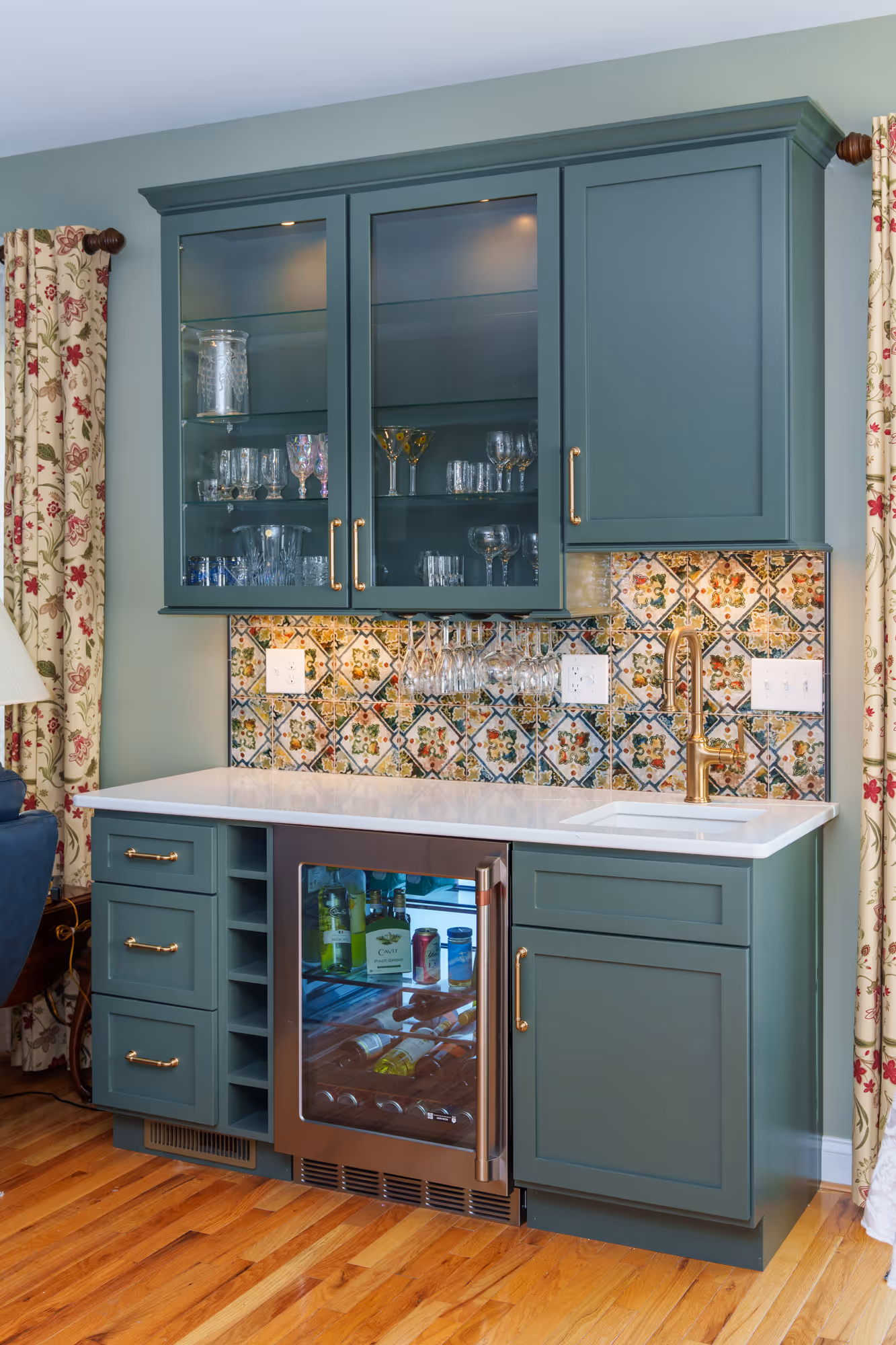 Transitional kitchen bar featuring colorful tile backsplash and green cabinetry in Harrisburg, PA