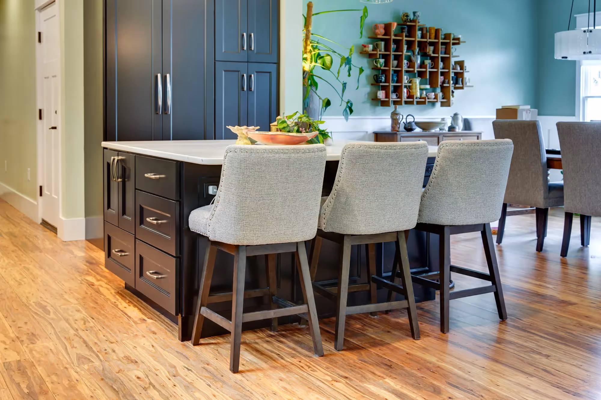 Dining area with dark cabinets, stools