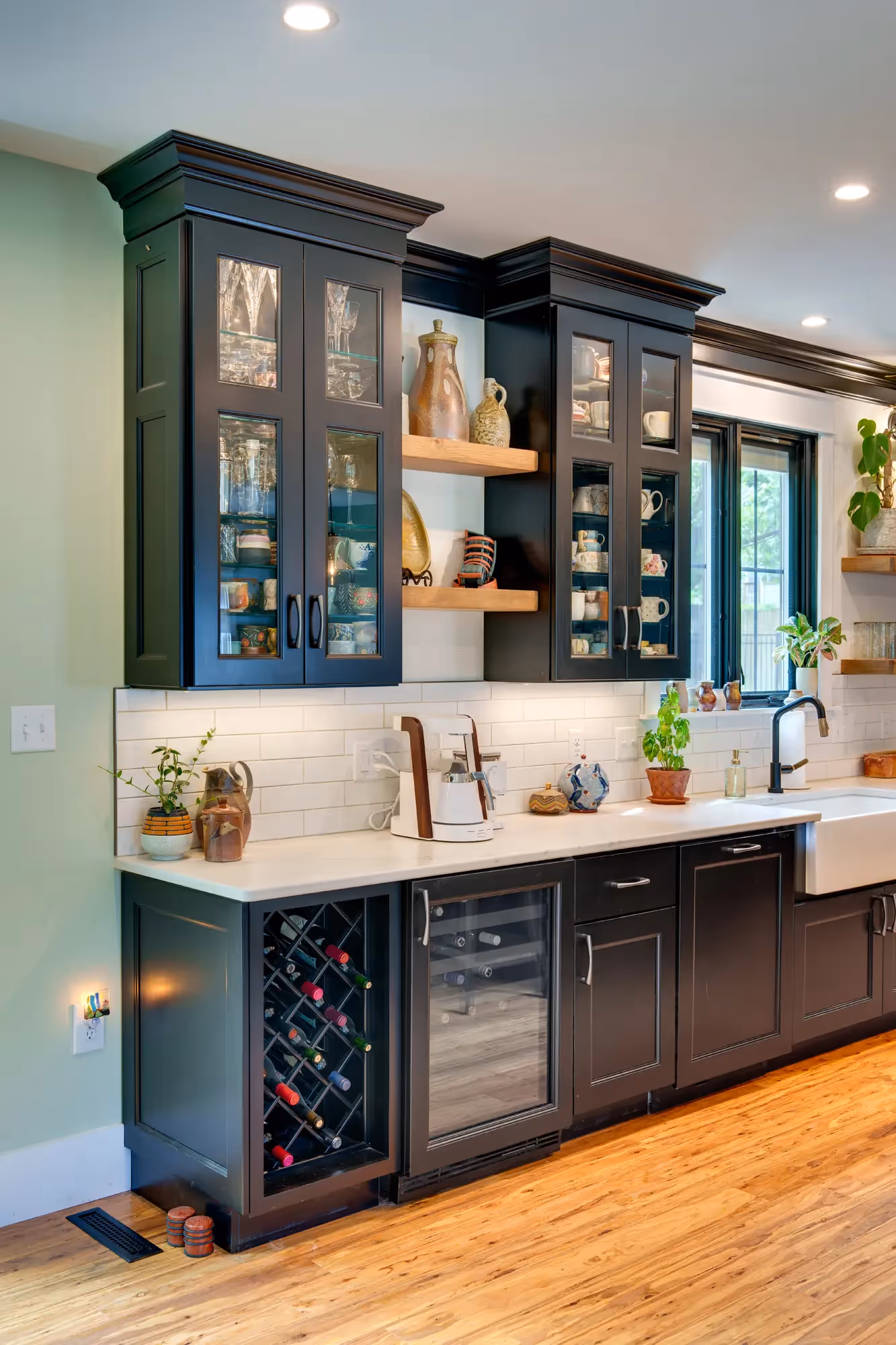 Modern kitchen with built-in shelving, dark cabinetry, and sleek design.