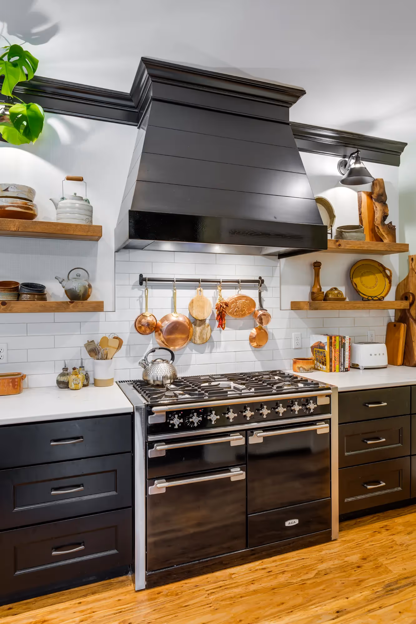 Close-up of stove area with decorative copper pots
