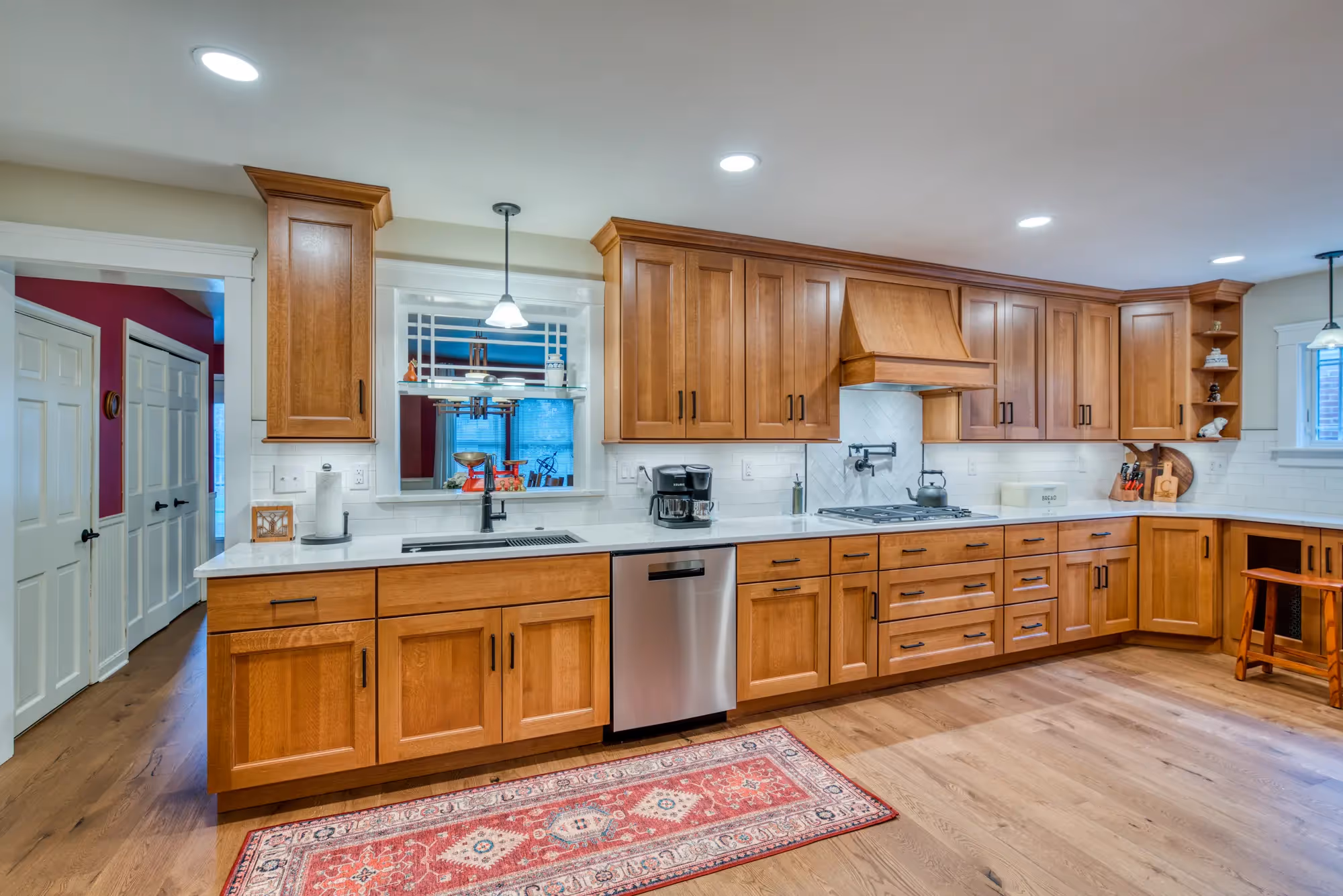 Spacious kitchen with wood flooring, modern appliances, and a clean layout.
