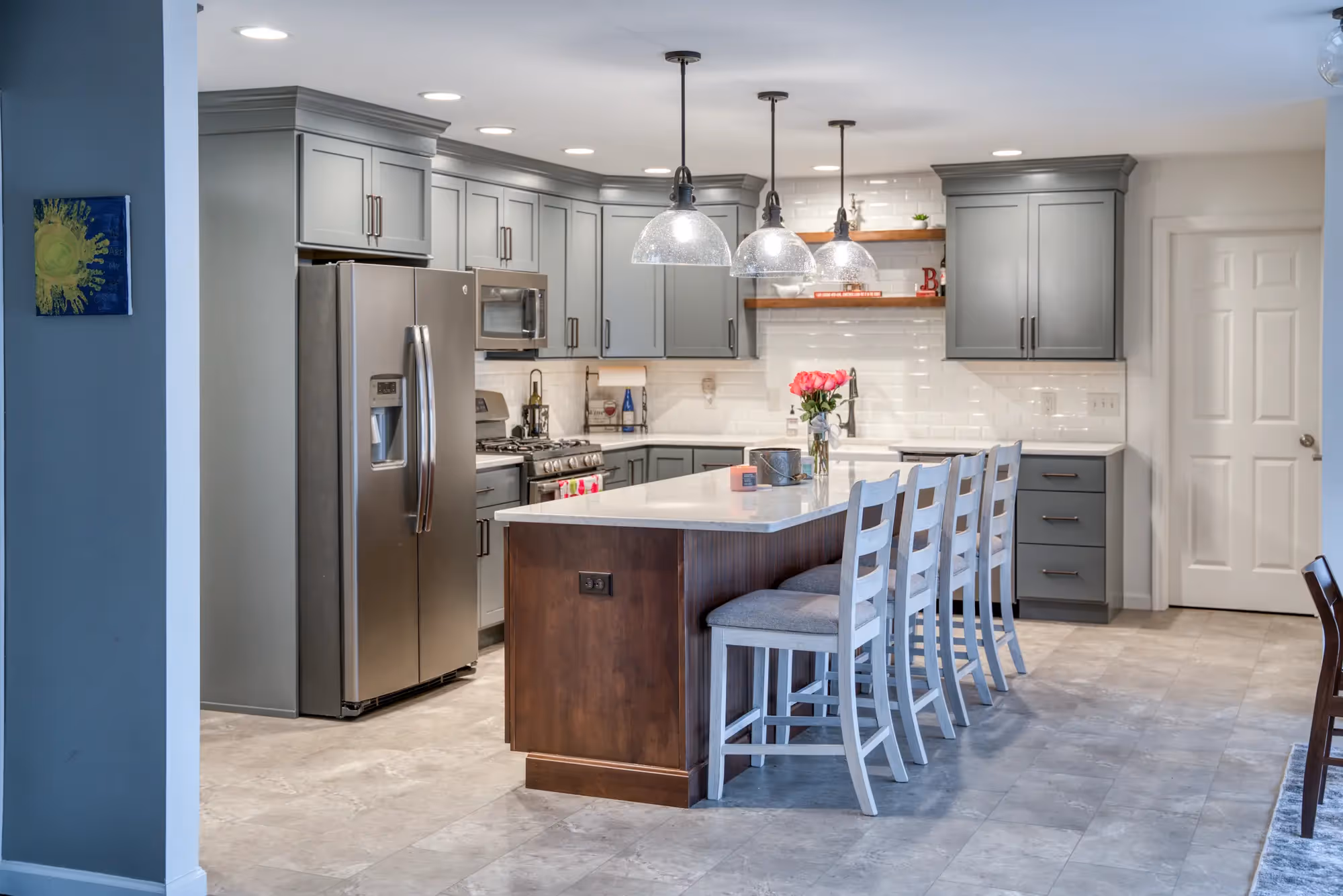 Bright kitchen with an island, pendant lights, and modern cabinetry