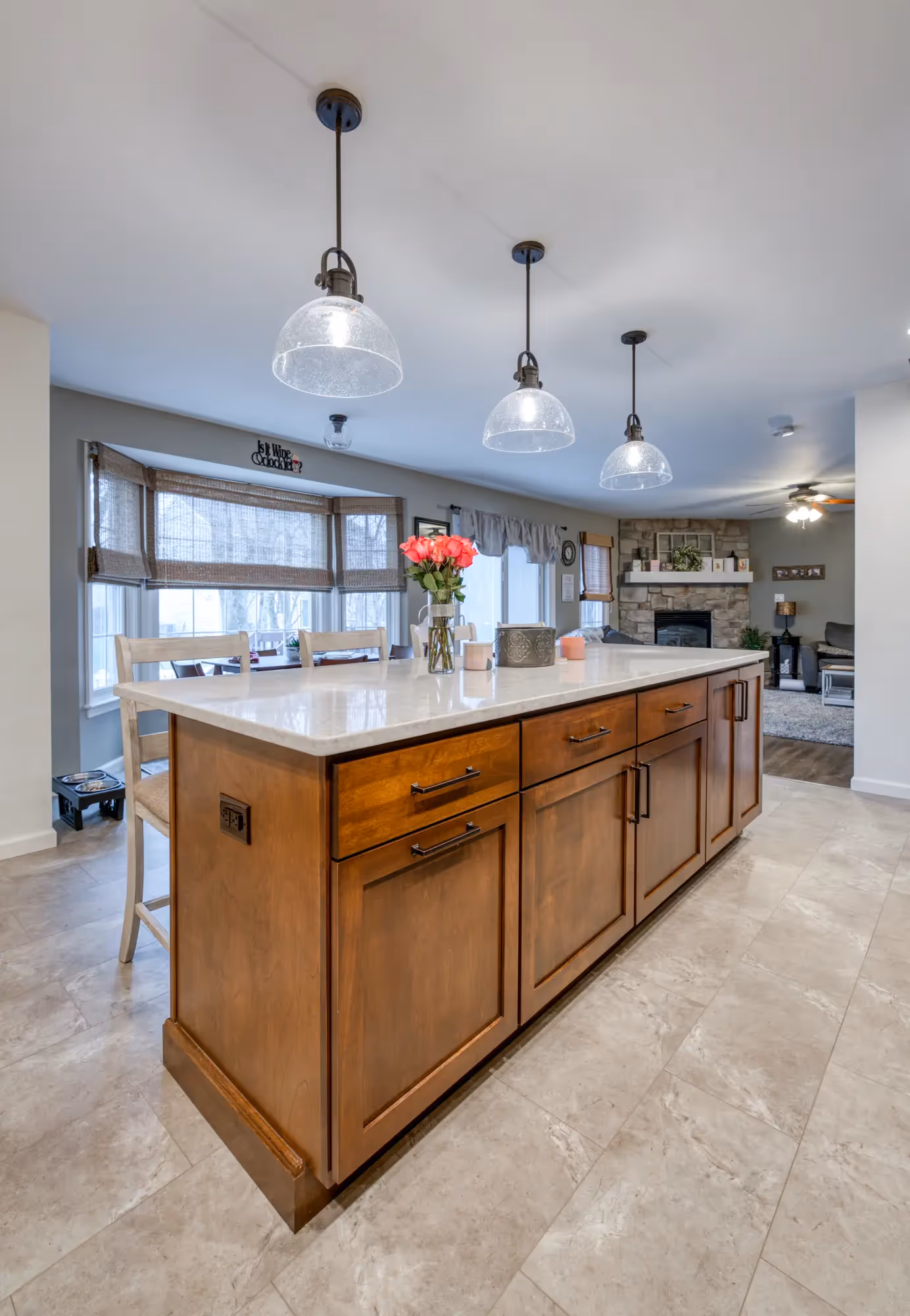 Close-up of the kitchen island with bar stools and wooden accents