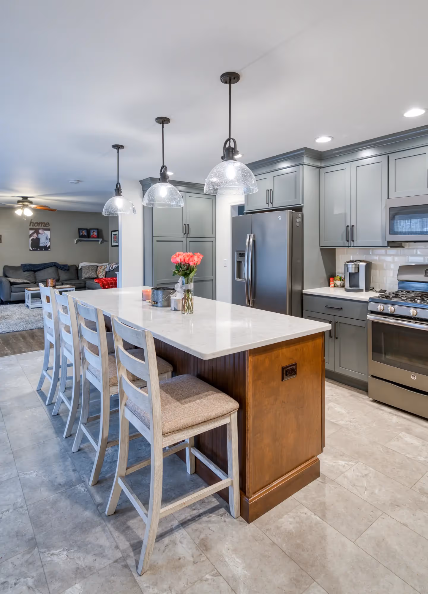Close-up of kitchen island with seating and open storage.