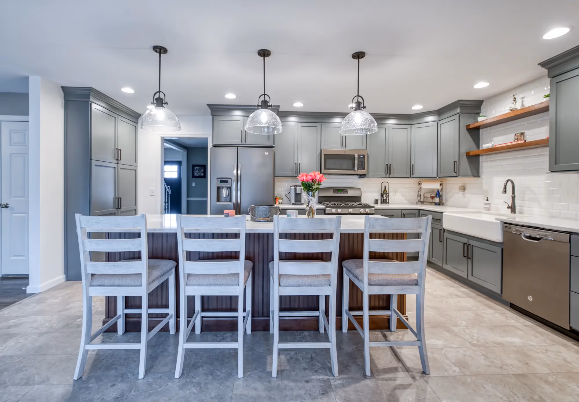 Bright kitchen with an island, pendant lights, and modern cabinetry