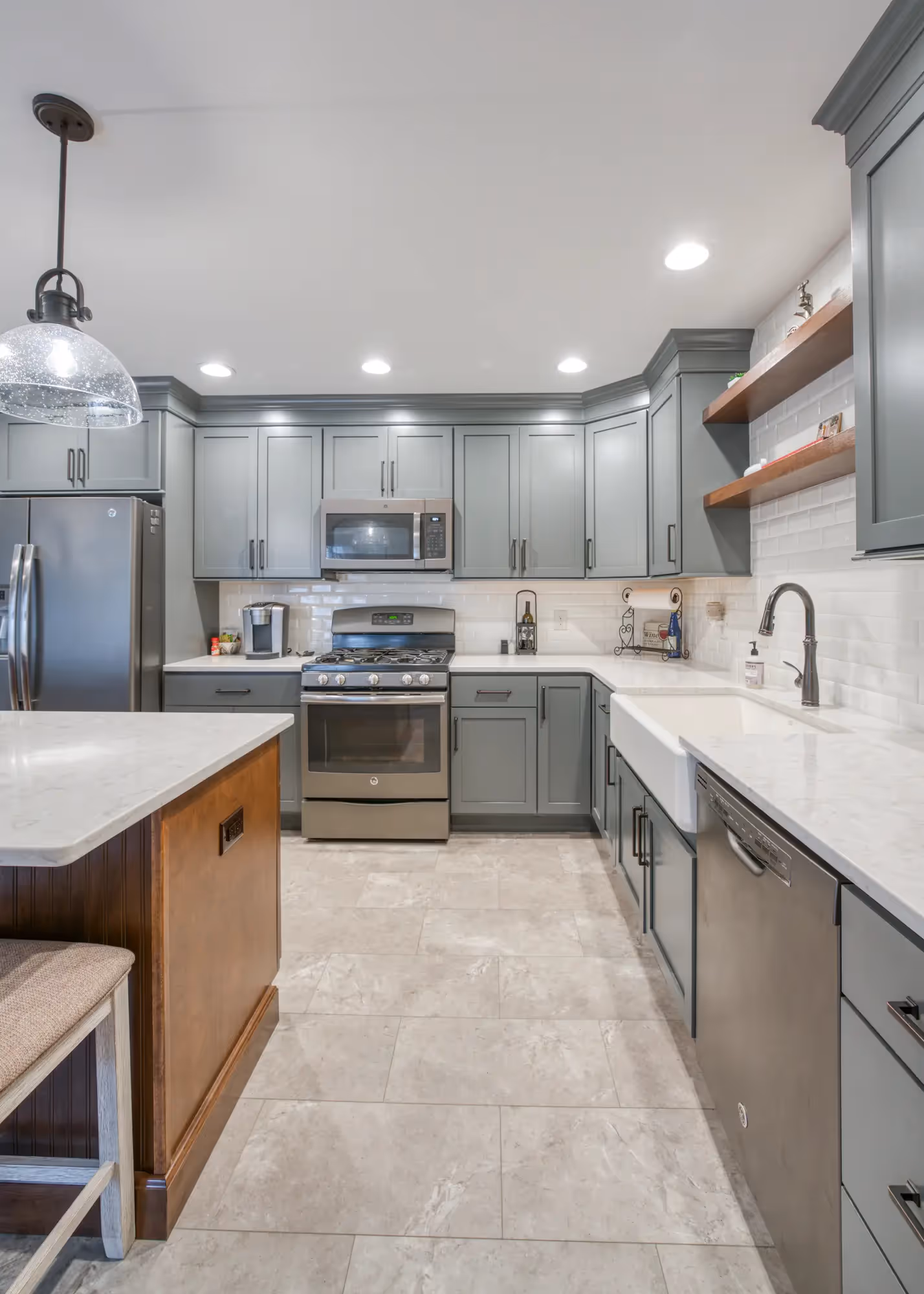 Bright kitchen with an island, pendant lights, and modern cabinetry