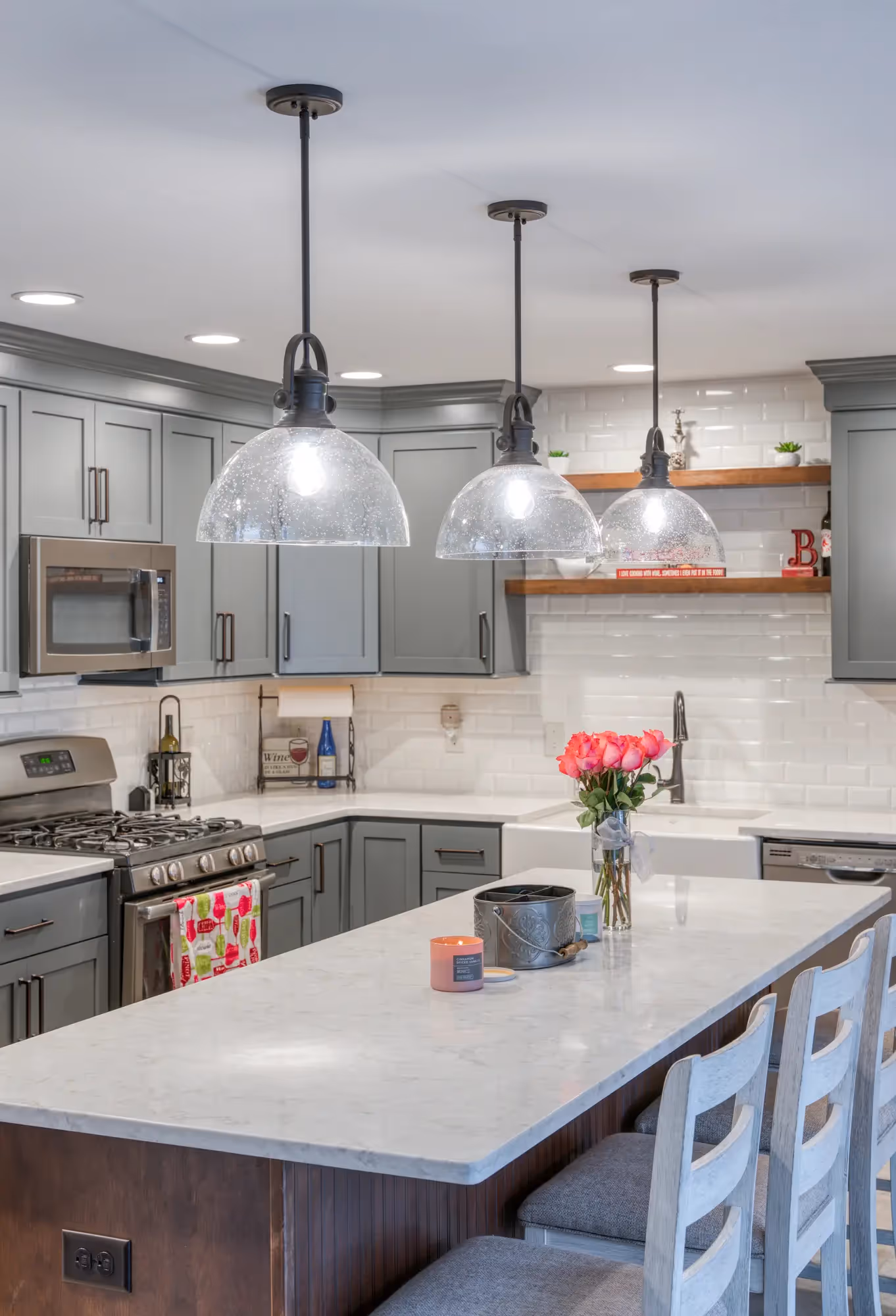Close-up of the kitchen island with bar stools and wooden accents