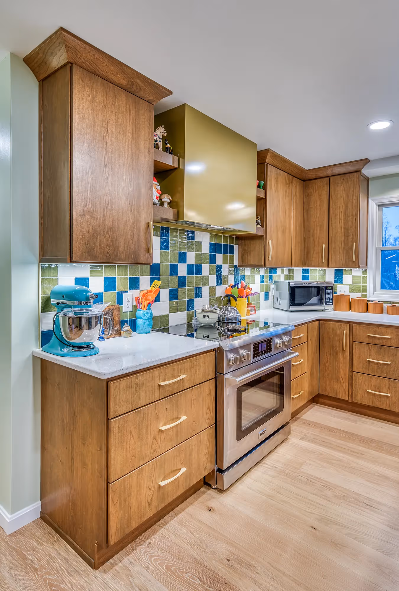 Kitchen with colorful tiles, wooden cabinets