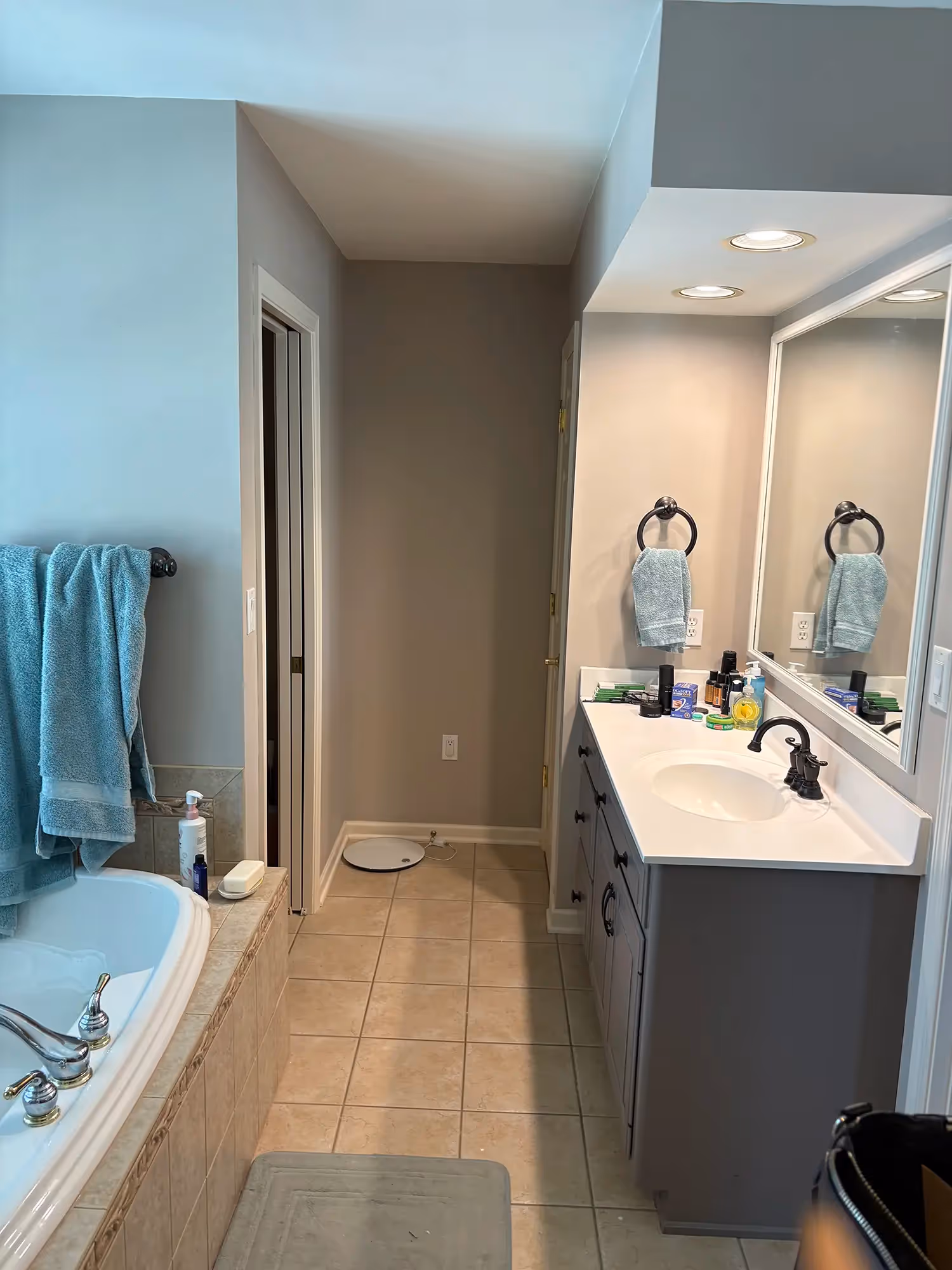 Bathroom with tub, neutral-colored walls