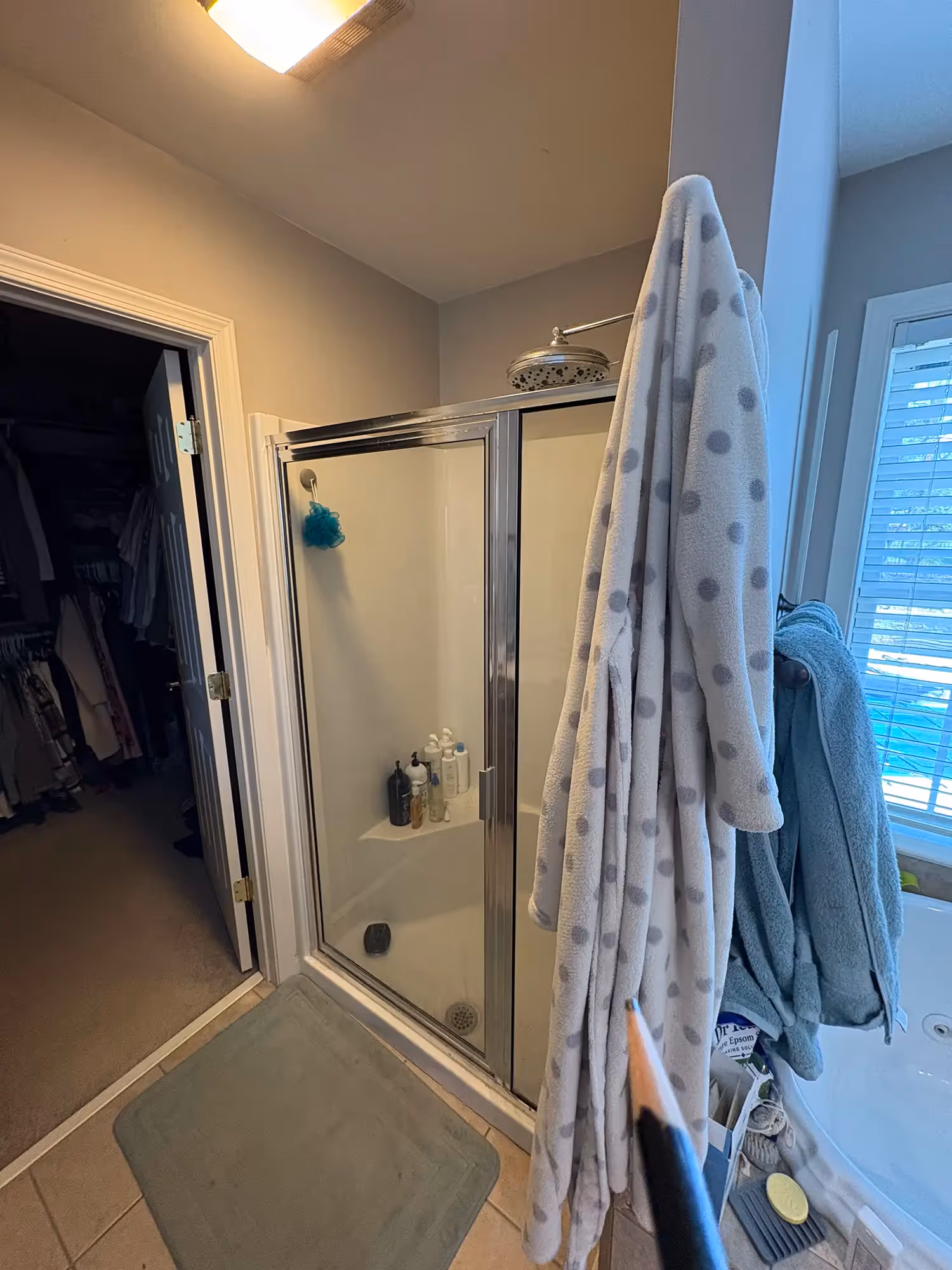Bathroom with tub, neutral-colored walls