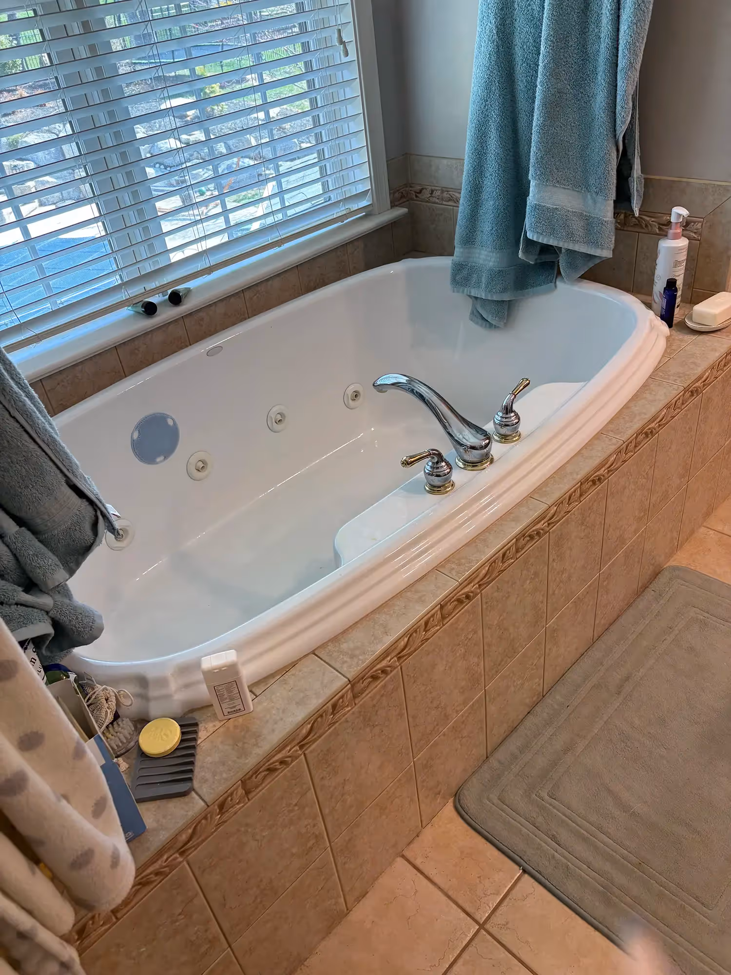 Bathroom with tub, neutral-colored walls