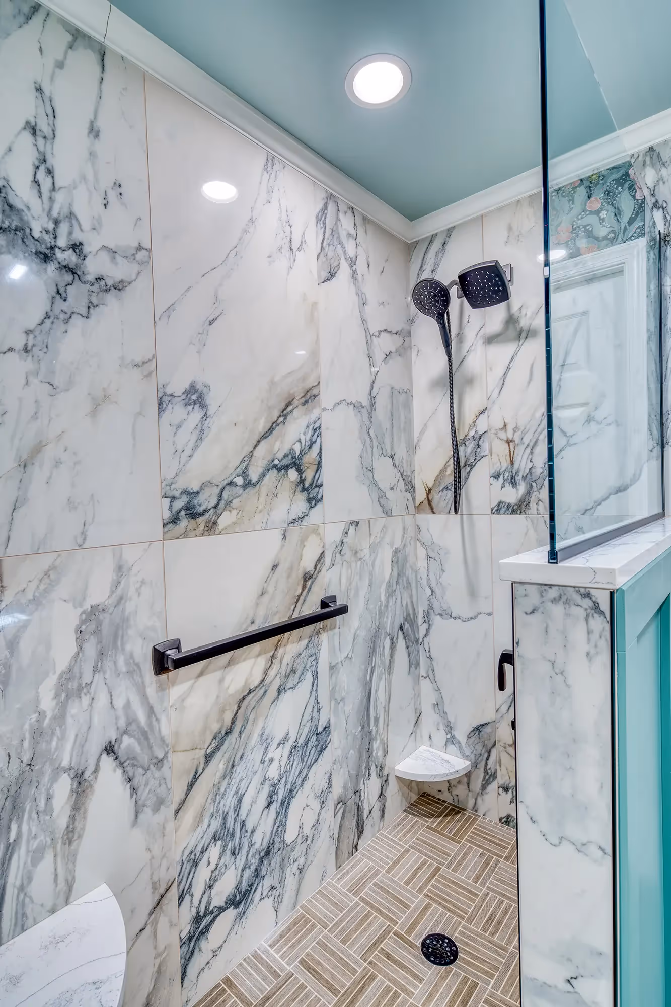 Bathroom with marble tiles, sleek shower design.