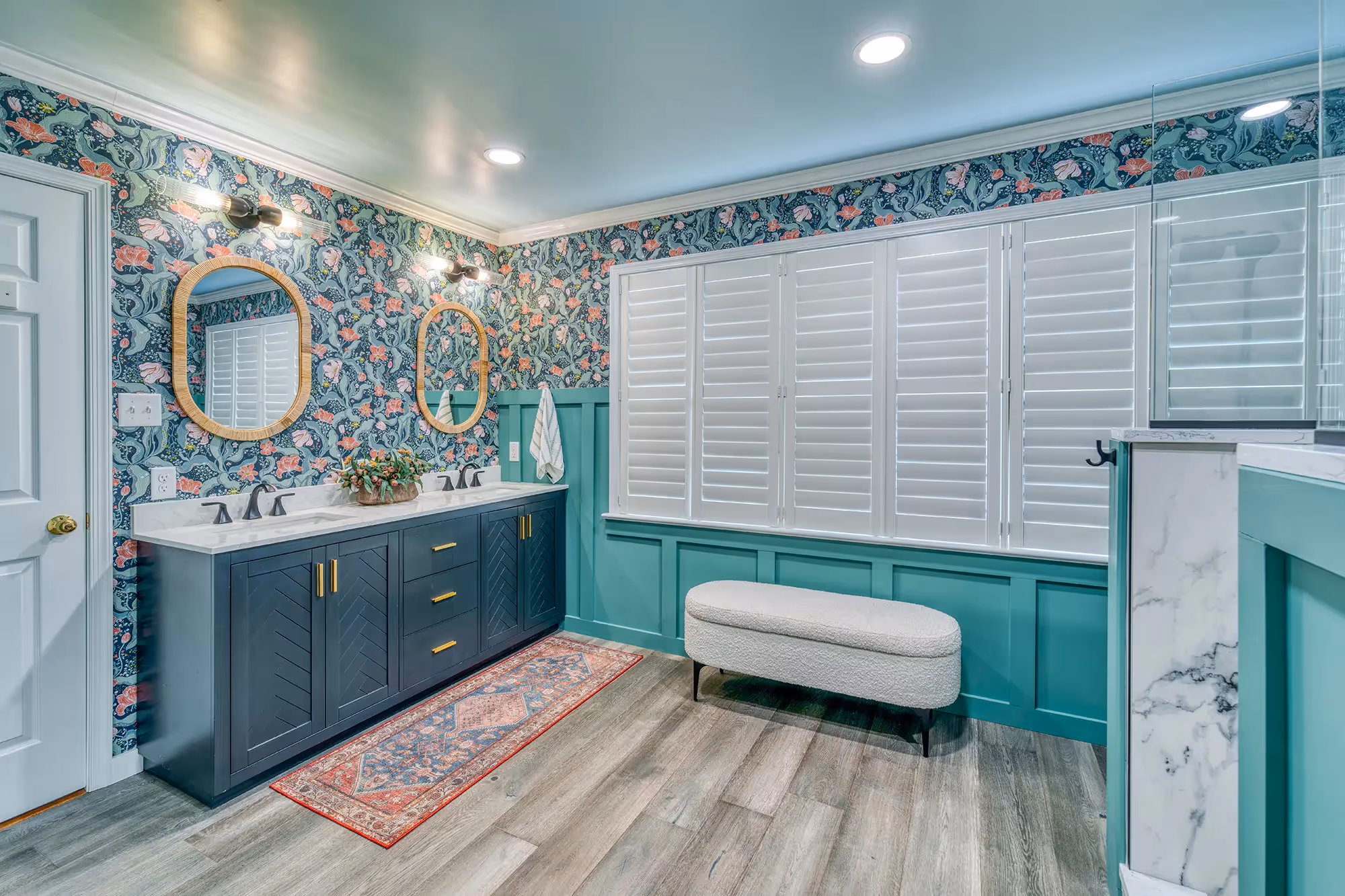 Vibrant bathroom with teal walls, floral wallpaper