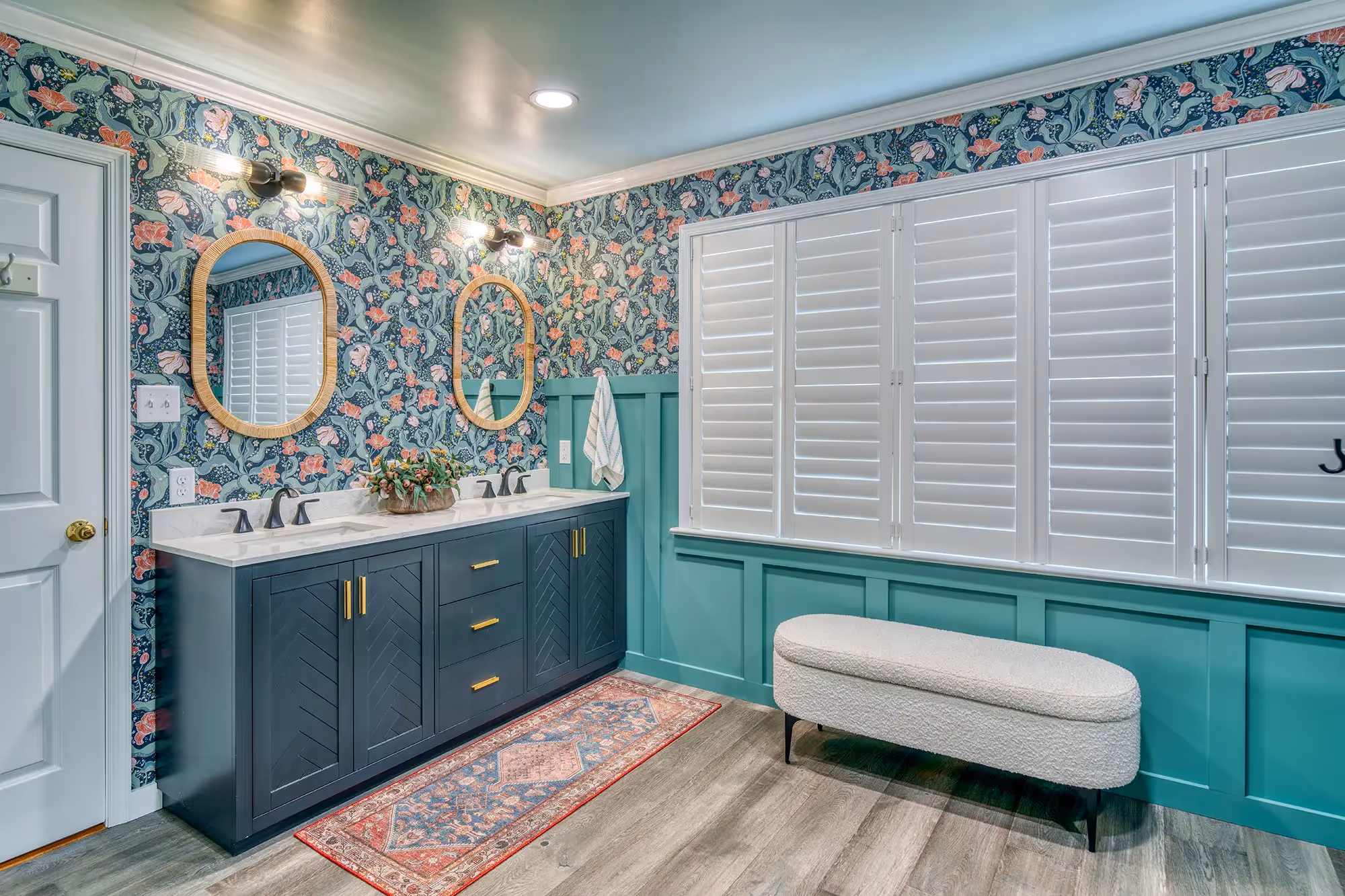 Vibrant bathroom with teal walls, floral wallpaper