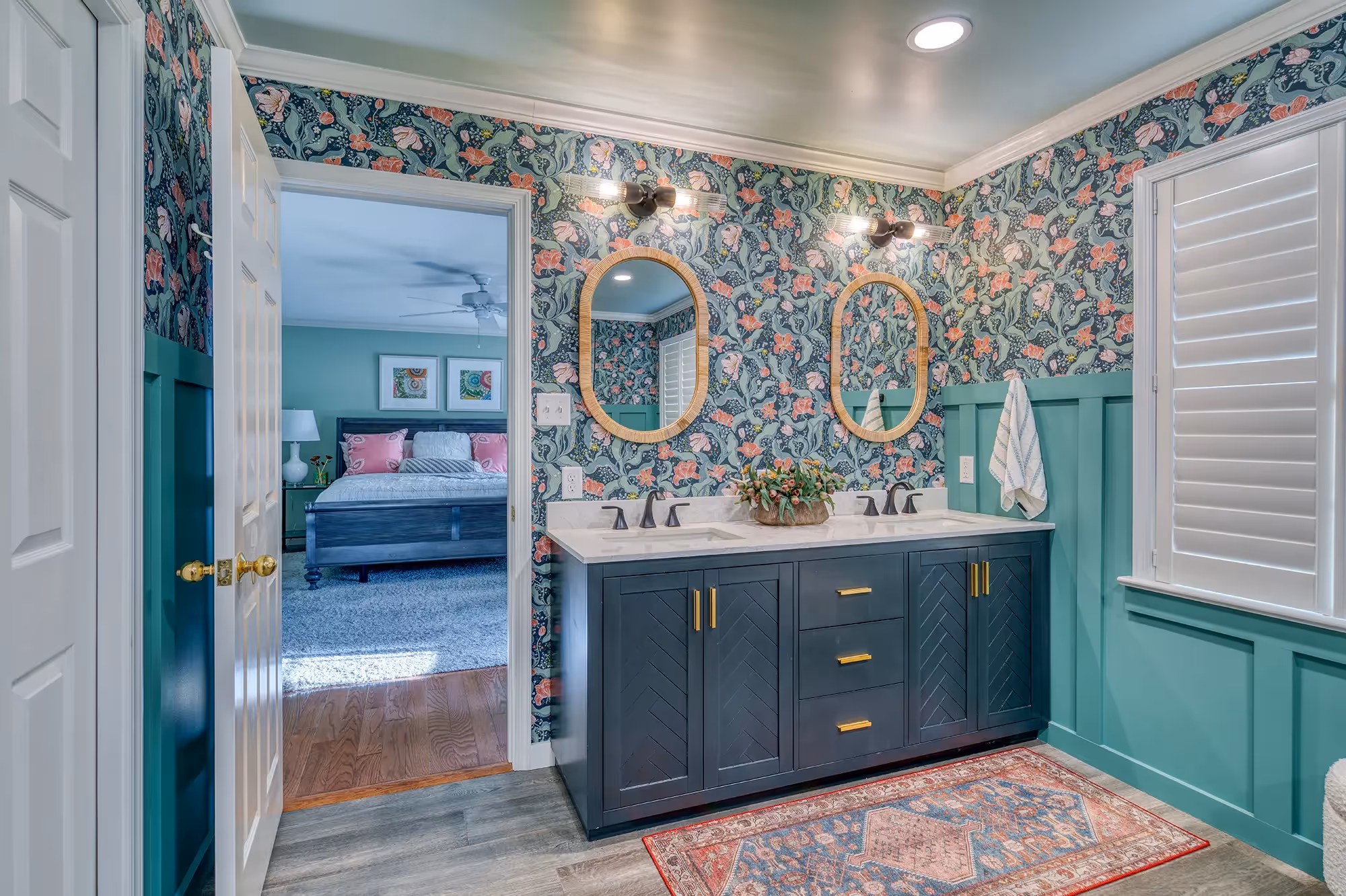 Vibrant bathroom with teal walls, floral wallpaper