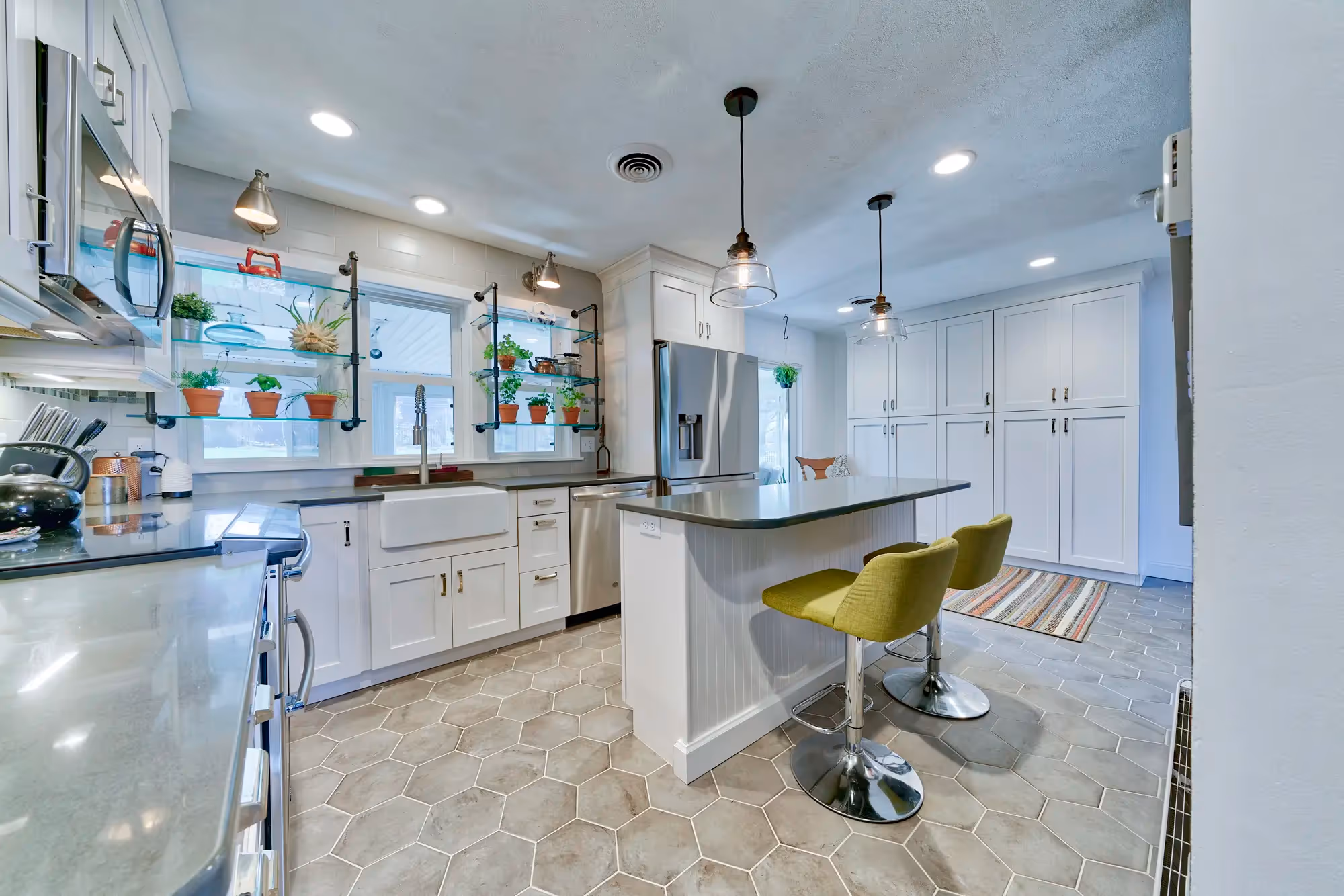 Kitchen area with white cabinetry, modern fixtures