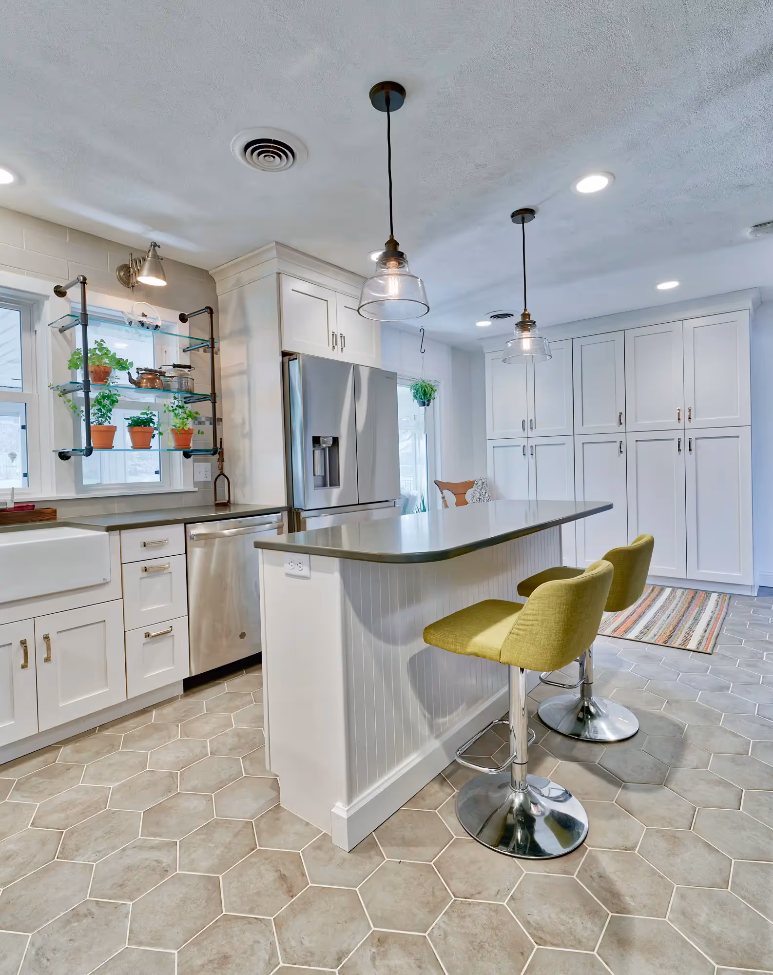 Kitchen area with white cabinetry, modern fixtures