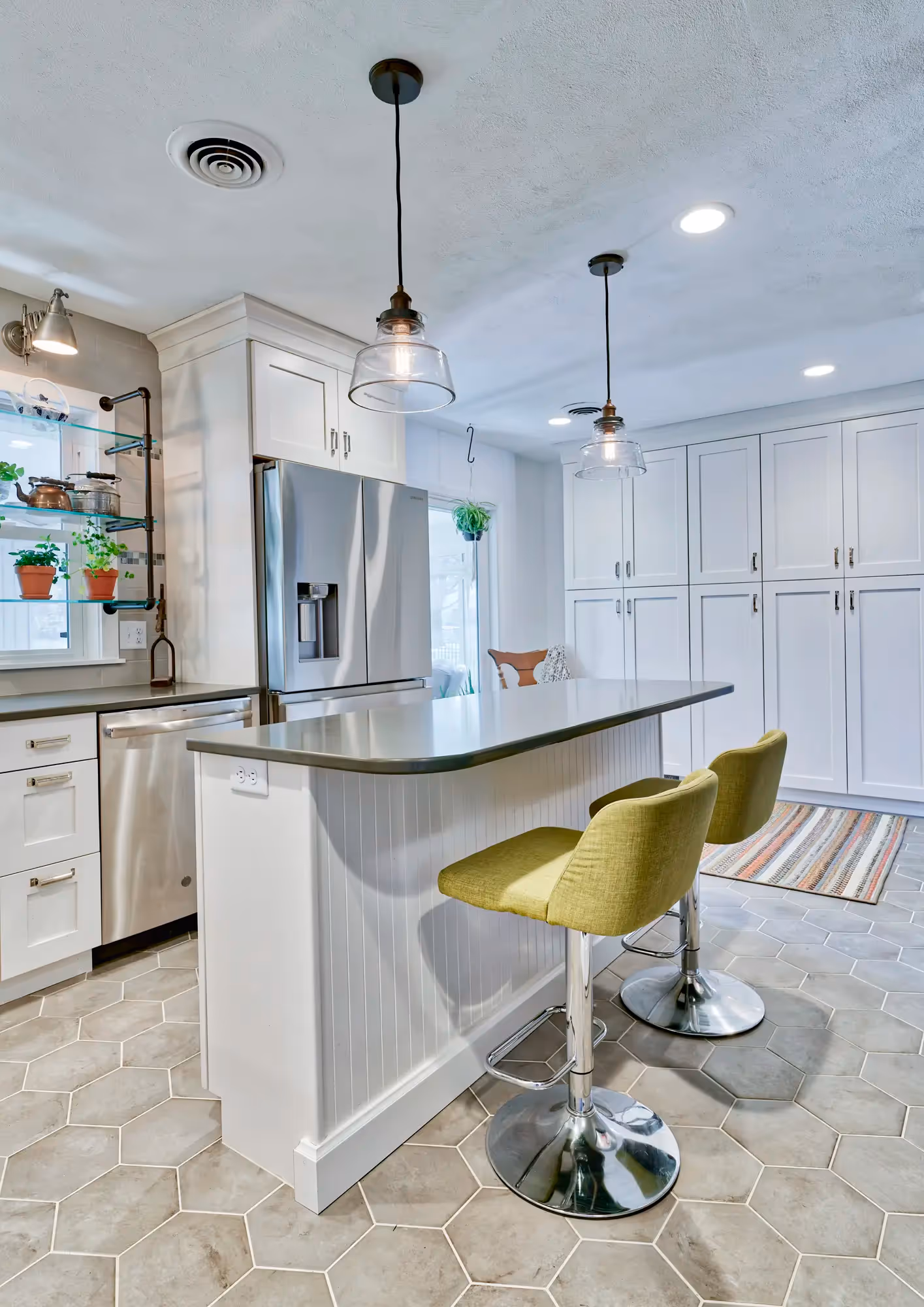 Kitchen area with white cabinetry, modern fixtures