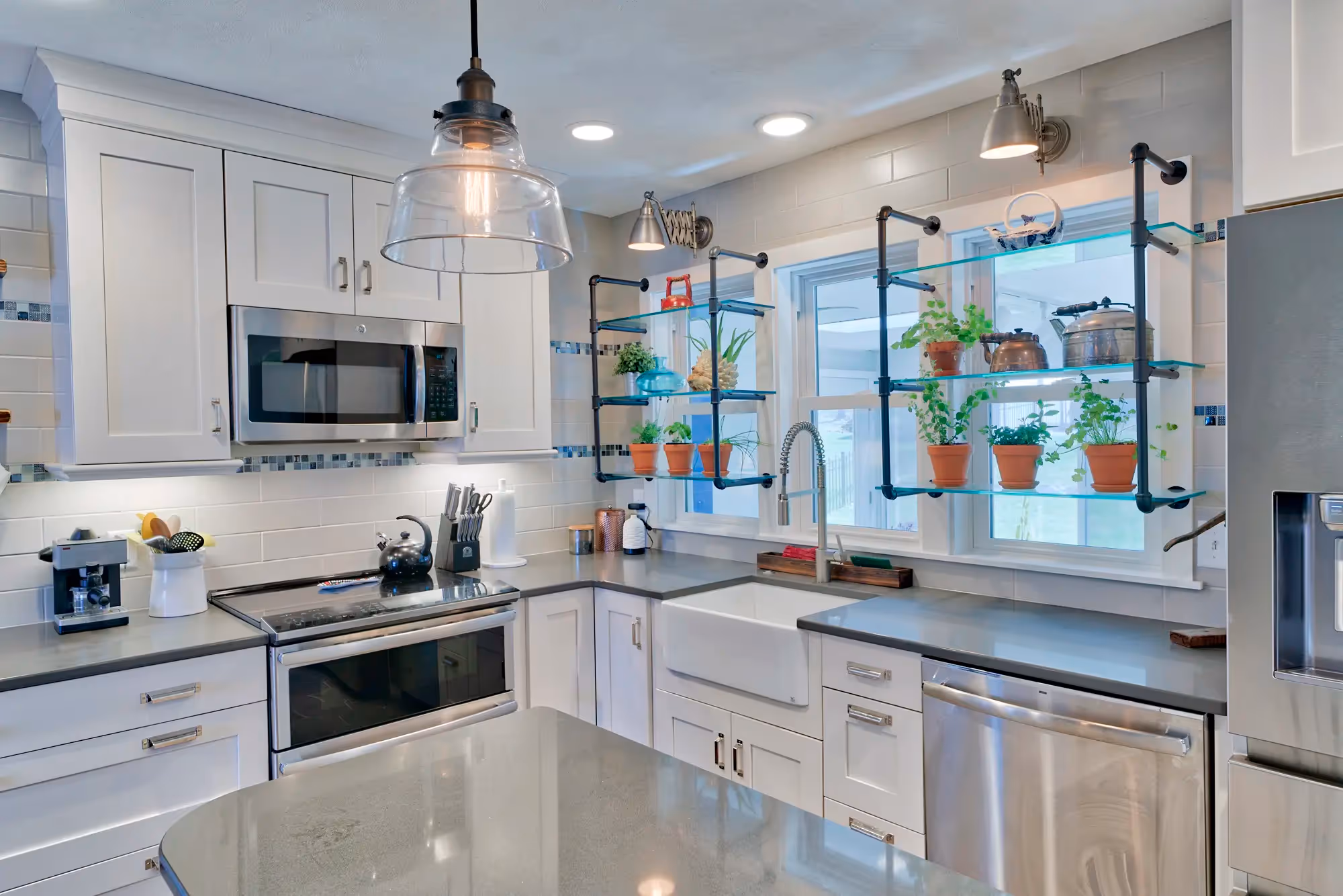 Kitchen area with white cabinetry, modern fixtures