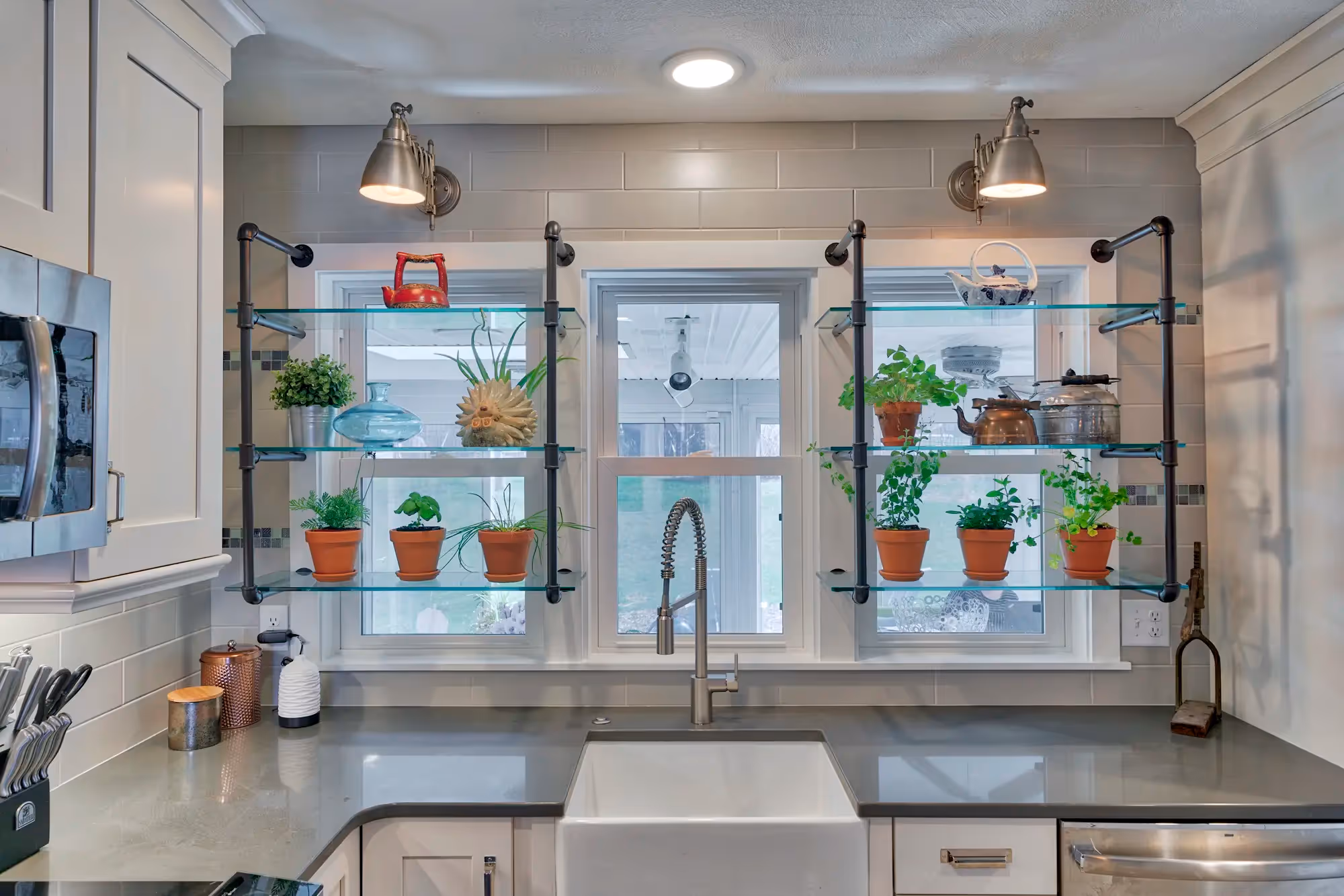 Kitchen area with white cabinetry, modern fixtures
