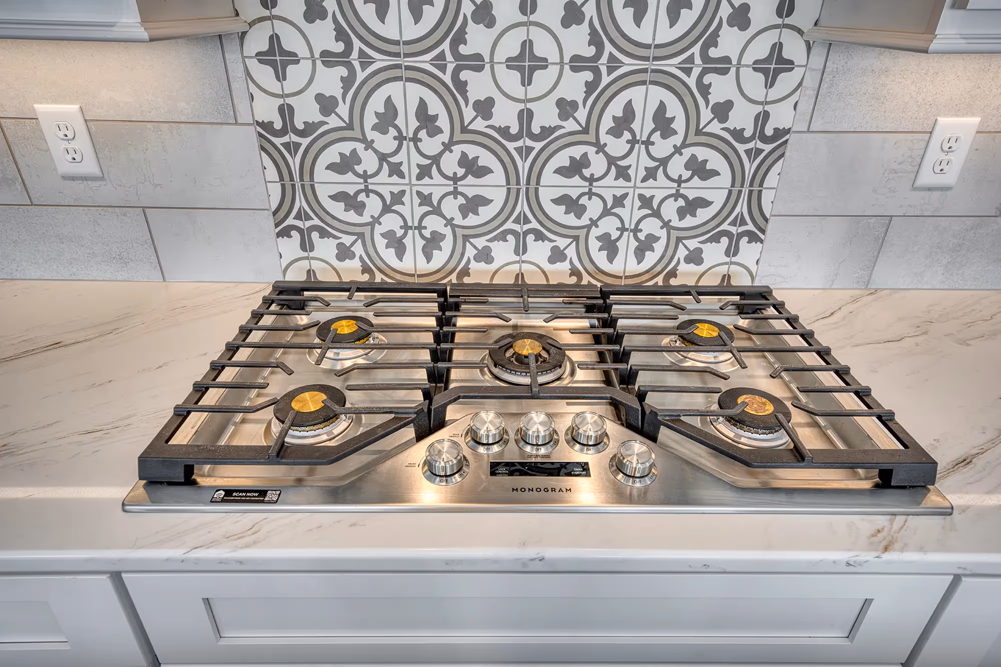 Stylish stove with detailed backsplash.