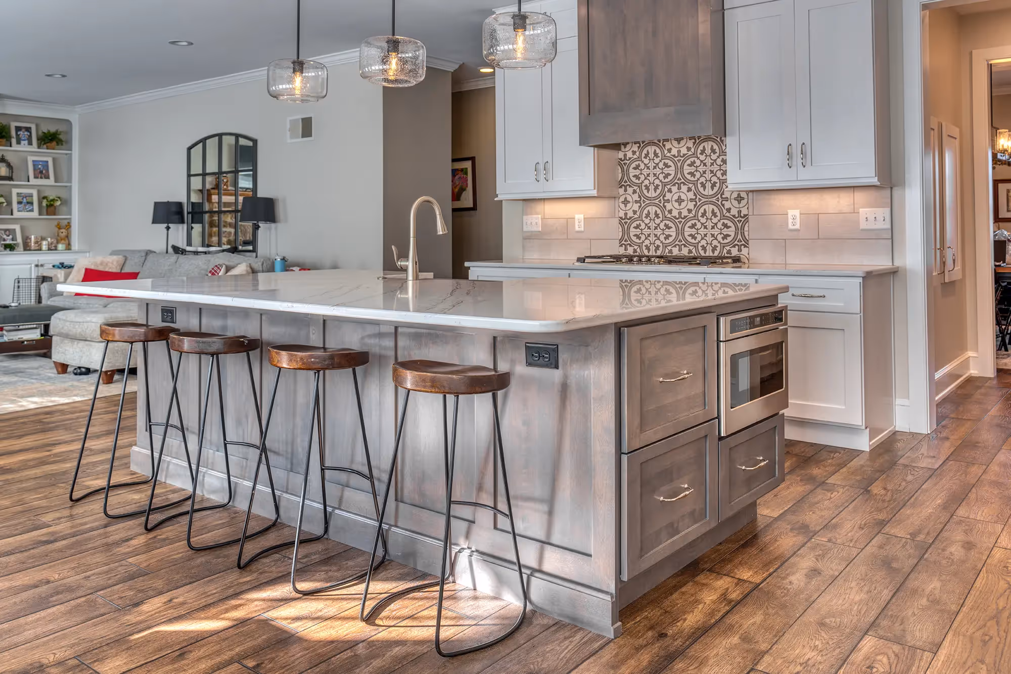 Chic kitchen with a marble island and stools.