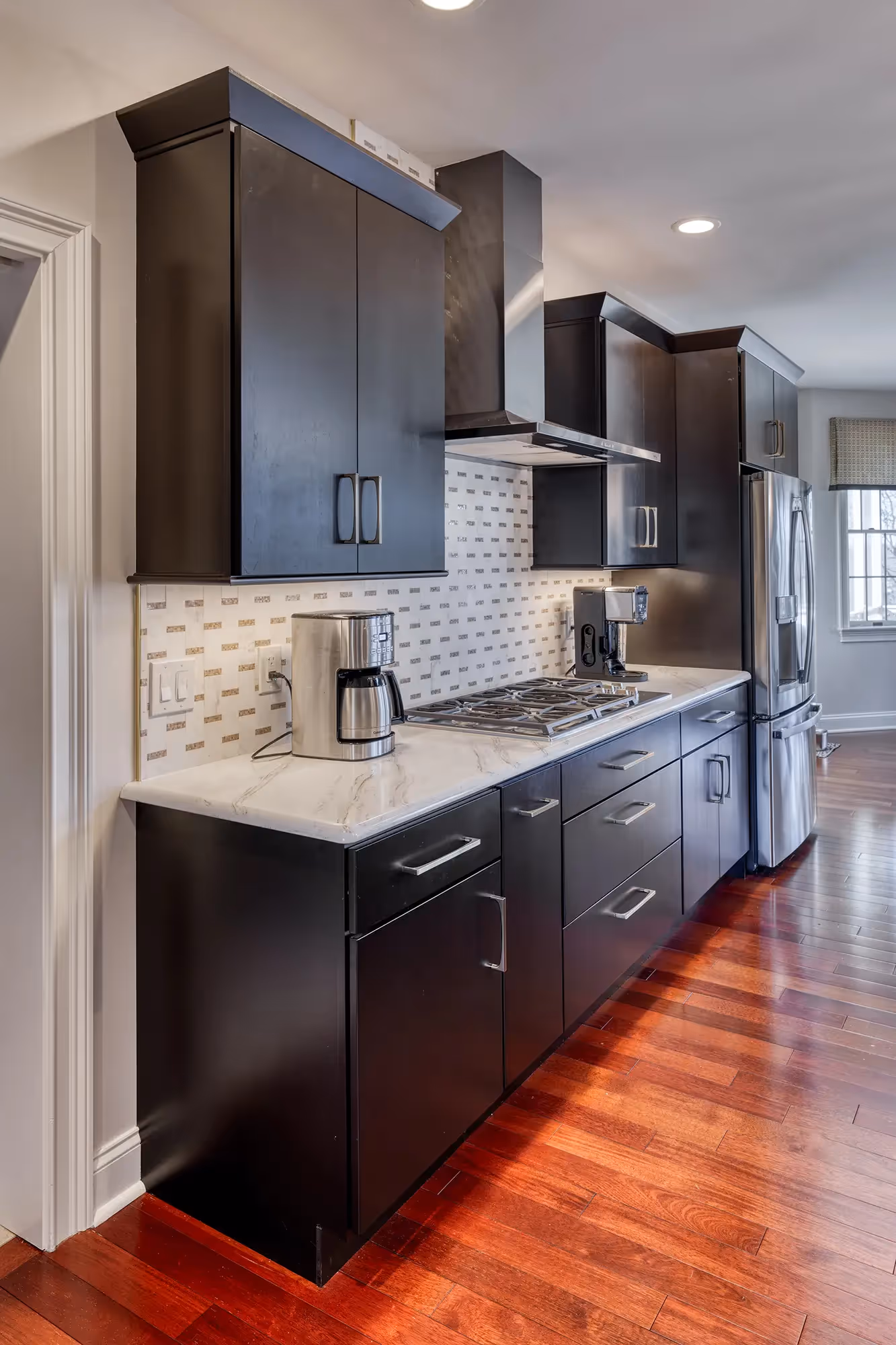 Spacious kitchen with dark cabinets