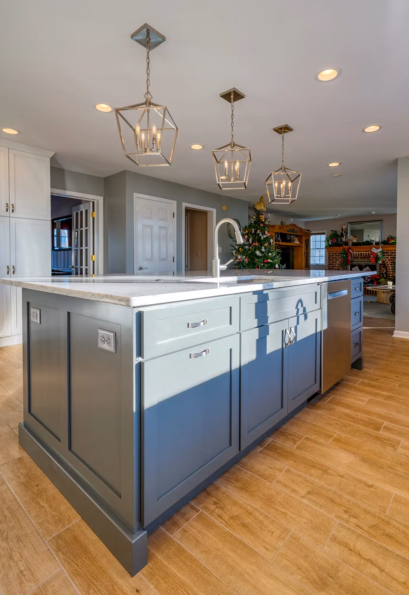 View of a long kitchen with white cabinets