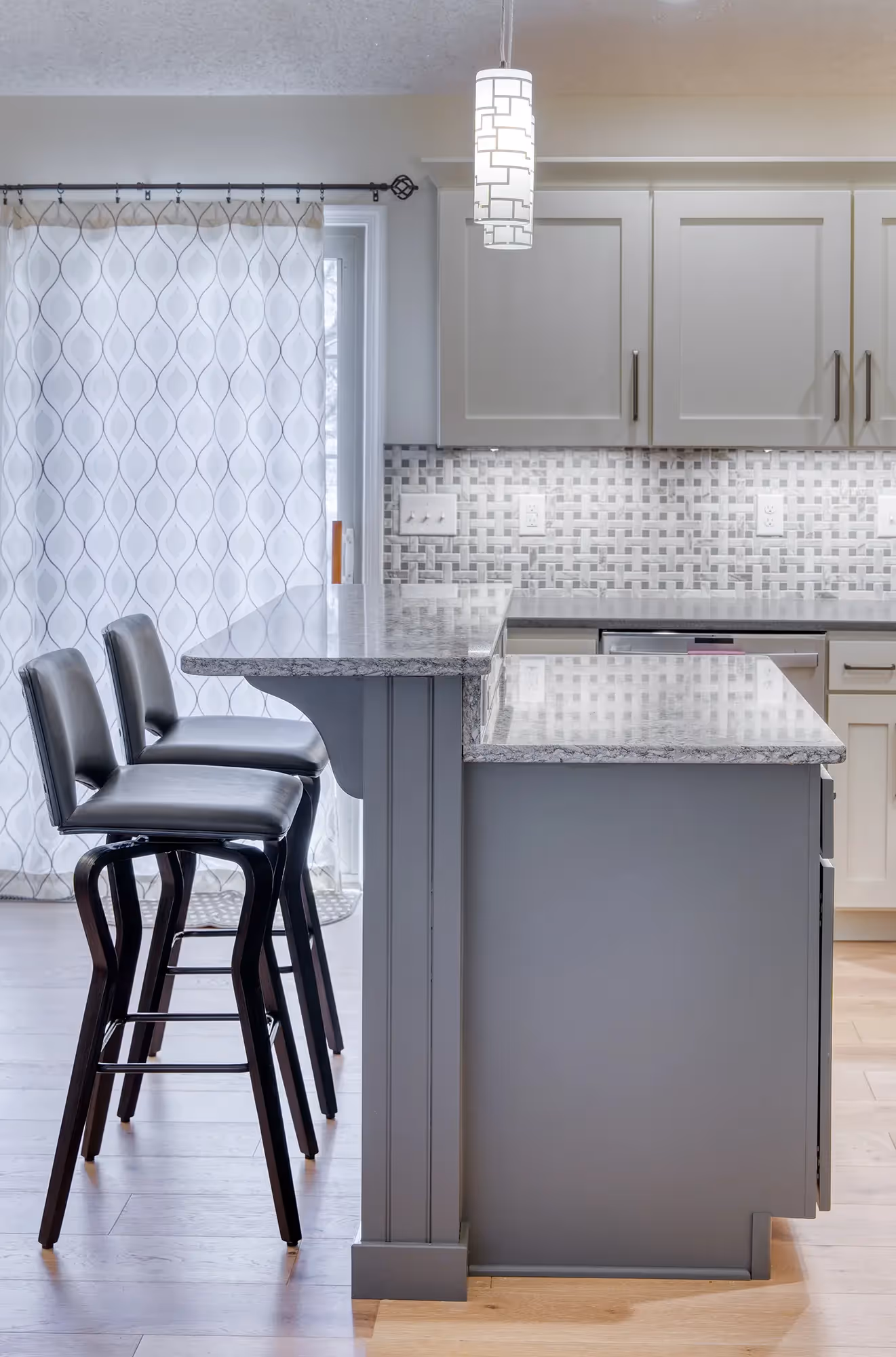 Corner of a modern kitchen with black stools