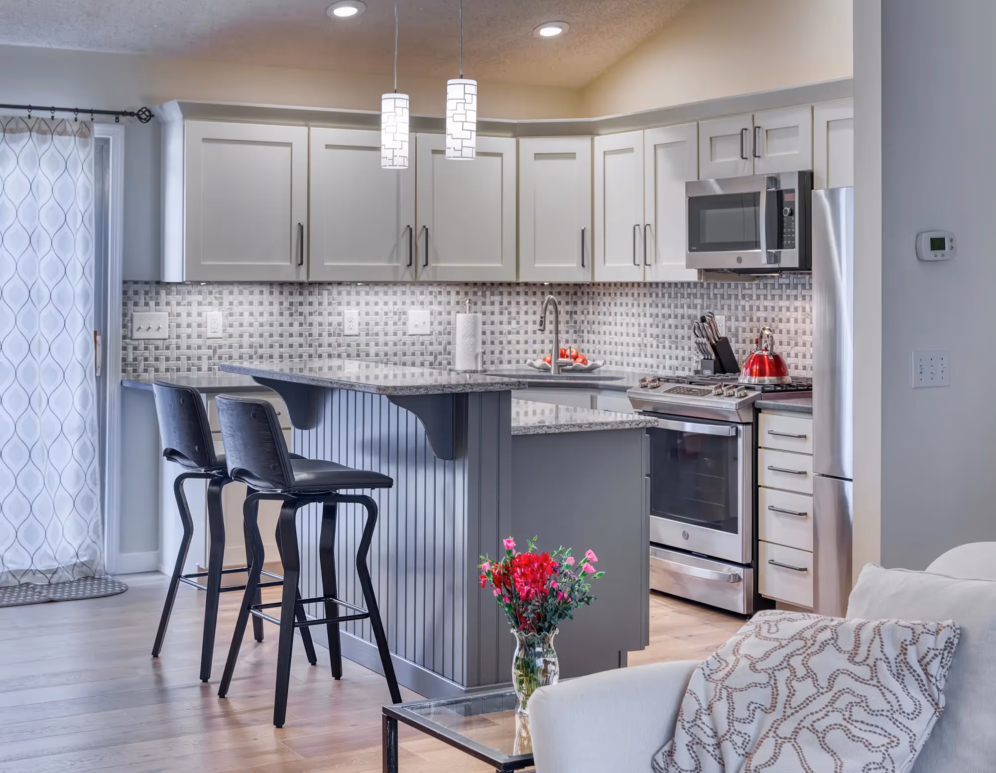 Kitchen island with gray base and stools