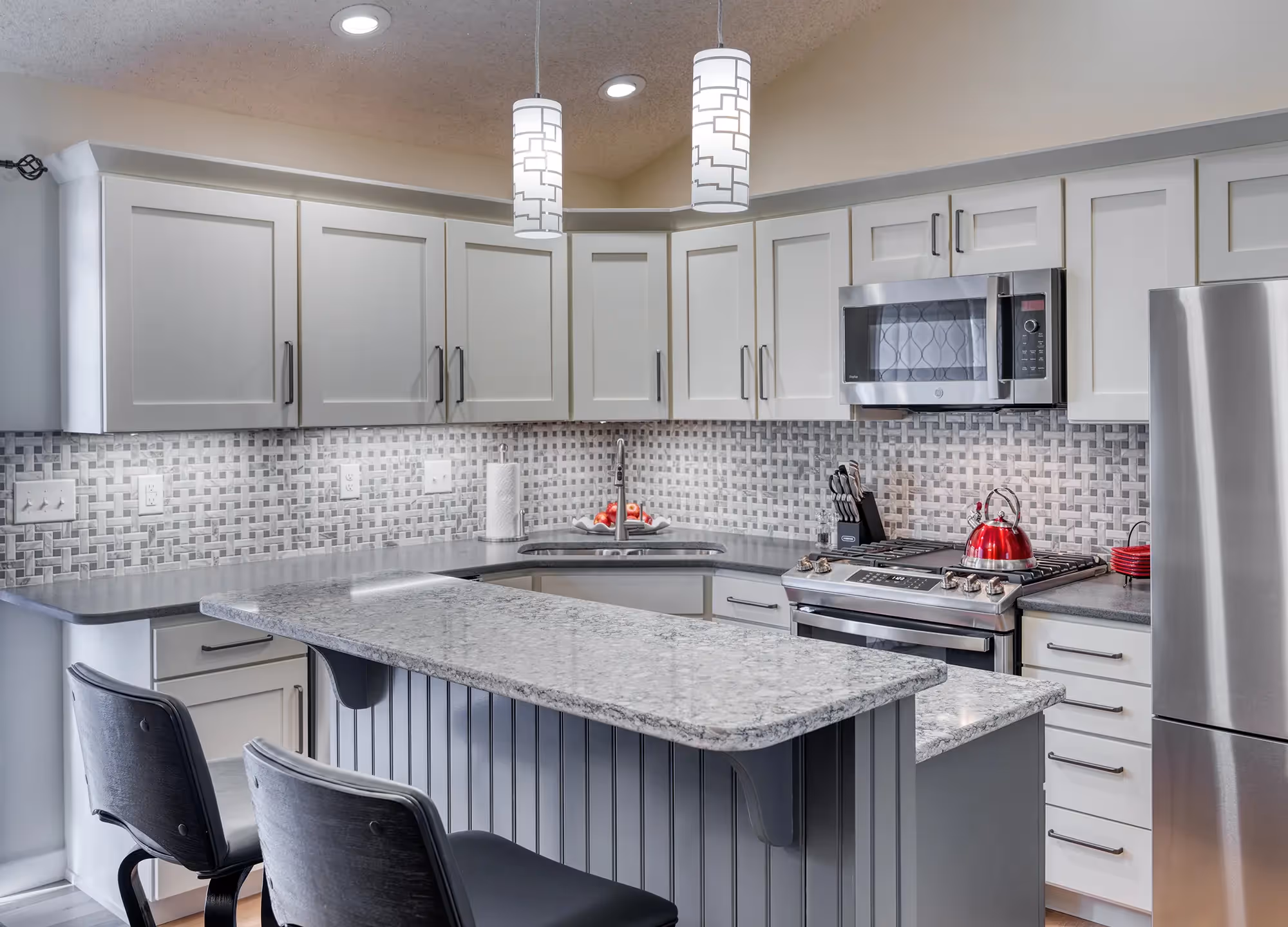 Close-up of stove and geometric tile backsplash
