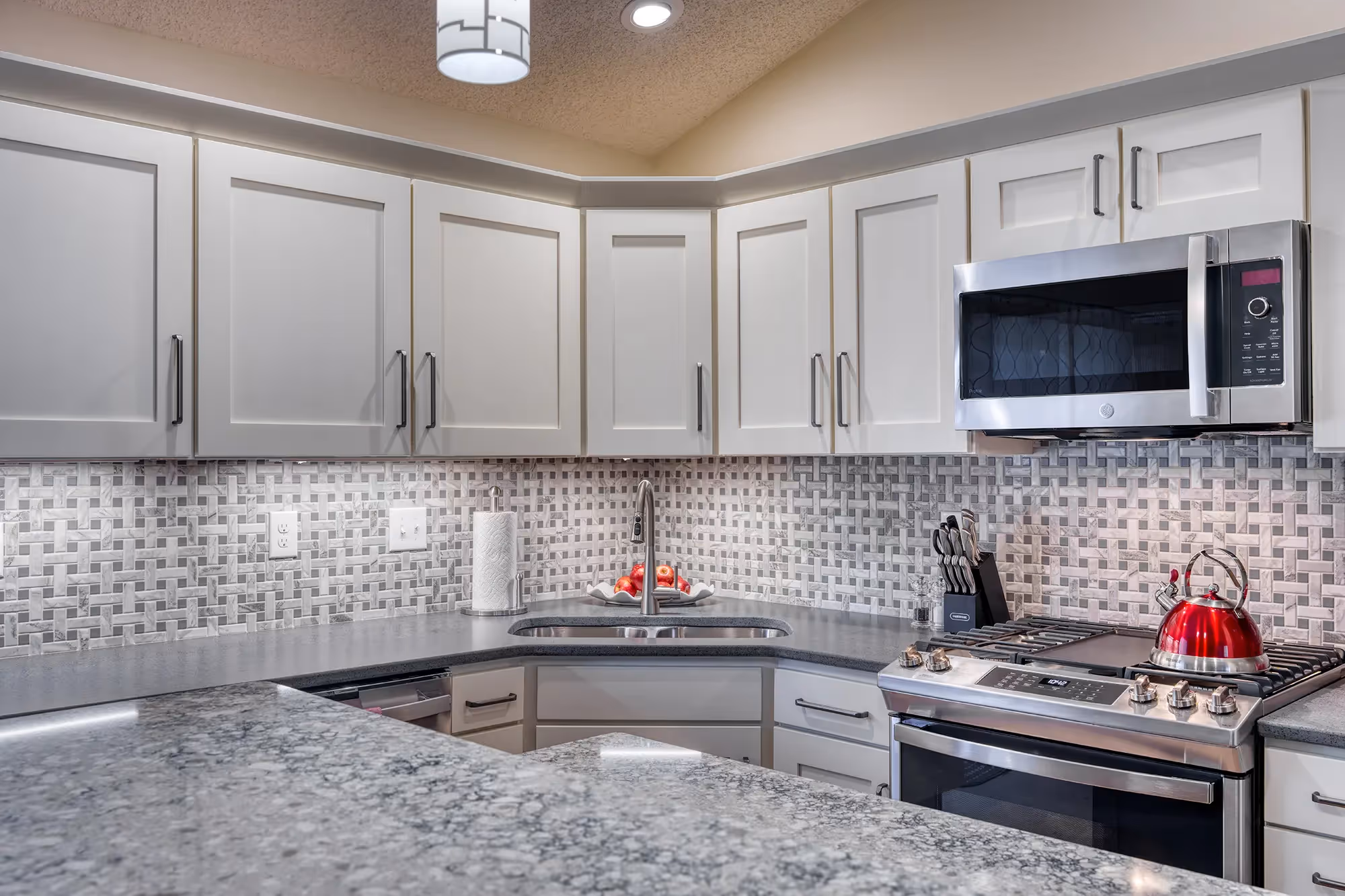 Kitchen island with gray base and stools