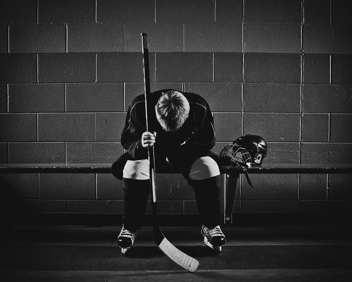 hockey-player-sitting-emotionally