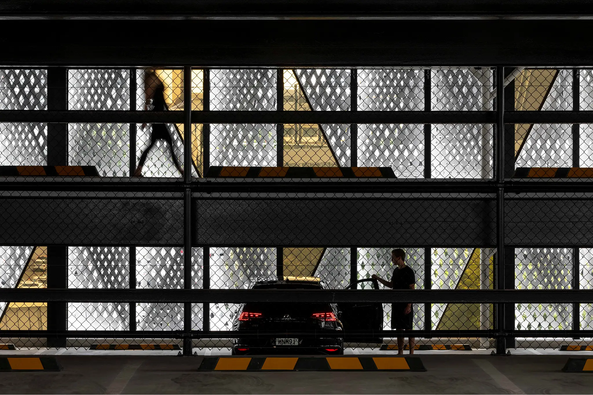 Image of a car parked inside a modern carparking building