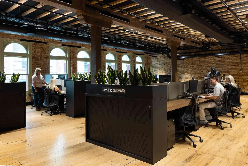 Modern office space with high ceilings and indoor plants