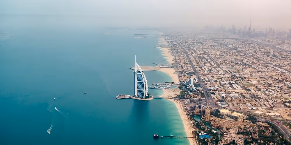 A top down photo of a Dubai beachfront featuring the Burj Al Arab