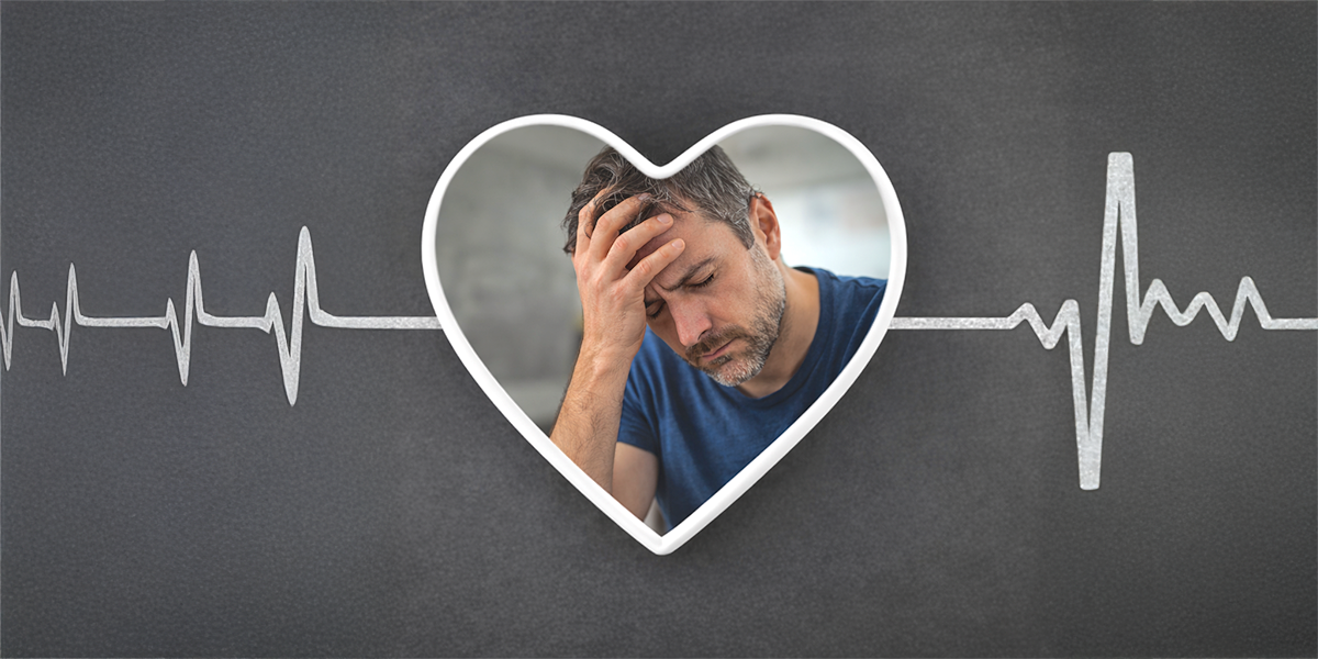 Man holding his head in exhaustion inside a heart shape with ECG line in background representing fatigue as a possible early sign of heart disease