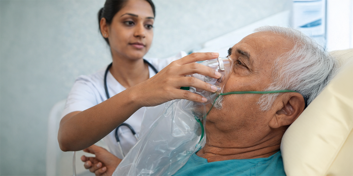 Healthcare professional providing oxygen mask to elderly patient illustrating oxygen support and the role of oxygen delivery in cellular and cardiovascular health