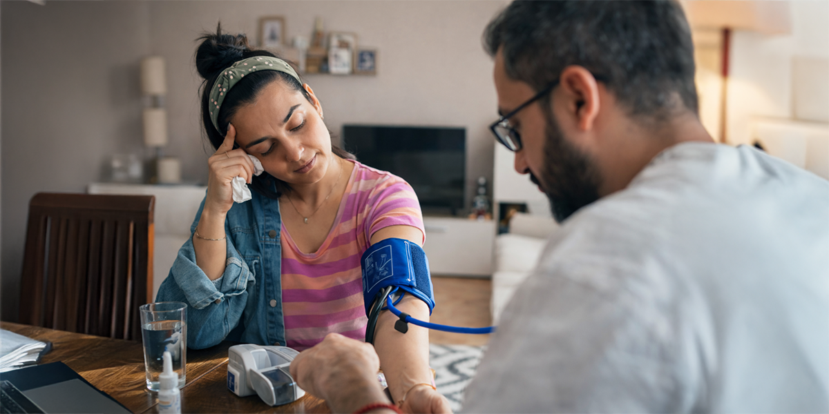 Woman having blood pressure checked while highlighting the concept of hidden heart disease risk despite normal medical tests