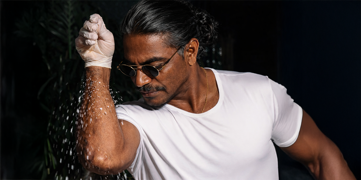 Man sprinkling salt with concept image representing high sodium intake and its effects on heart and blood vessel health