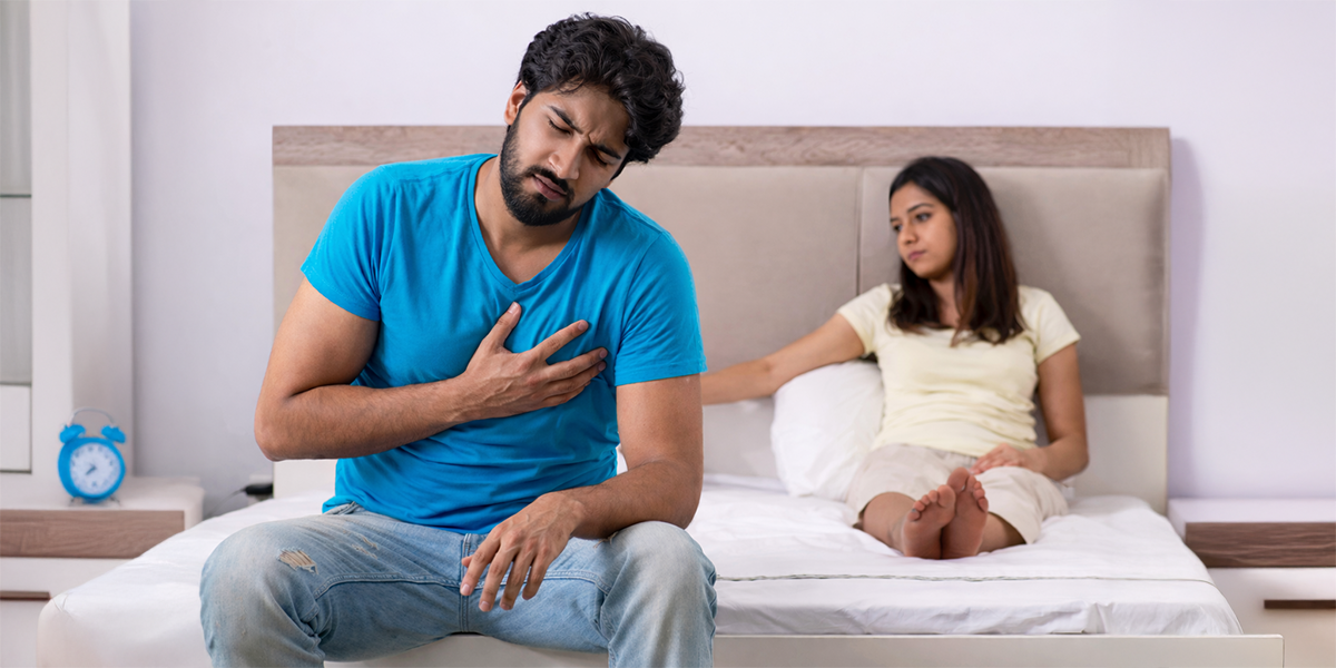 Couple experiencing fertility concerns sitting on bed representing infertility and reproductive health challenges