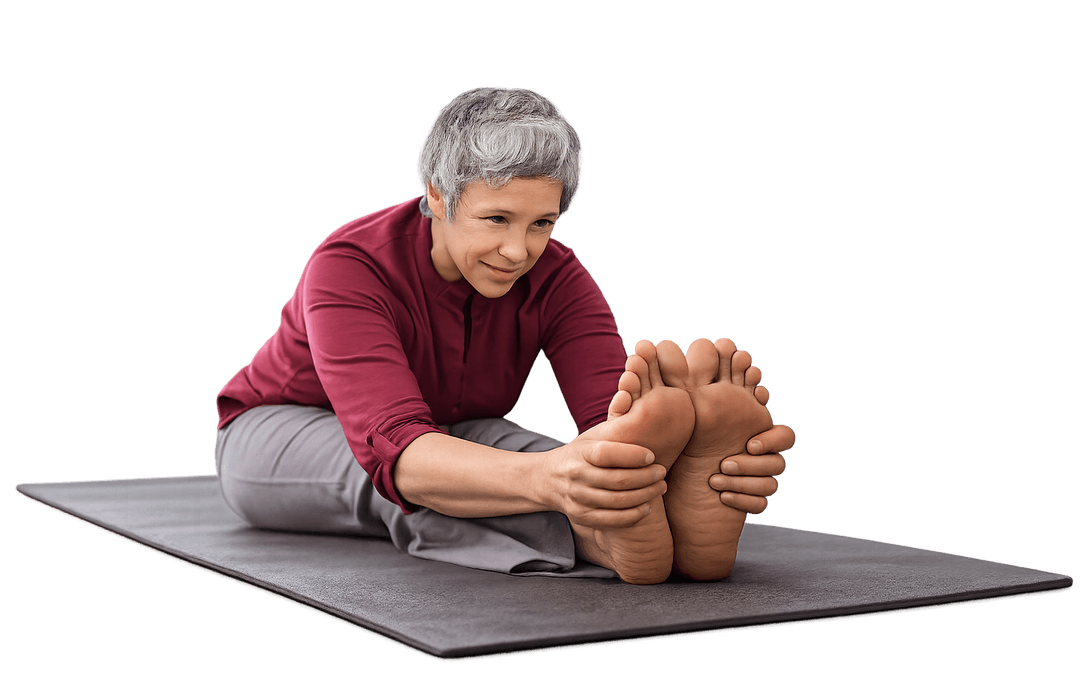 Older adult performing stretching exercise on a yoga mat representing mobility, balance, and preventive wellness practices.